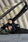 KUNSAN AIR BASE, Republic of Korea -- A crew chief helps secure Capt. Mason Enright, 35th Fighter Squadron pilot, into the cockpit as he prepares to take off in his F-16 Fighting Falcon aircraft Feb. 10 to participe in a Combined Large Force Employment training exercise. The CLFE consists of four different units including the 35th FS, the 80th FS, Republic of Korea Air Force and the 36th FS based out of Osan AB, ROK. (U.S. Air Force photo/Tech. Sgt. Jonathan Pomeroy) 