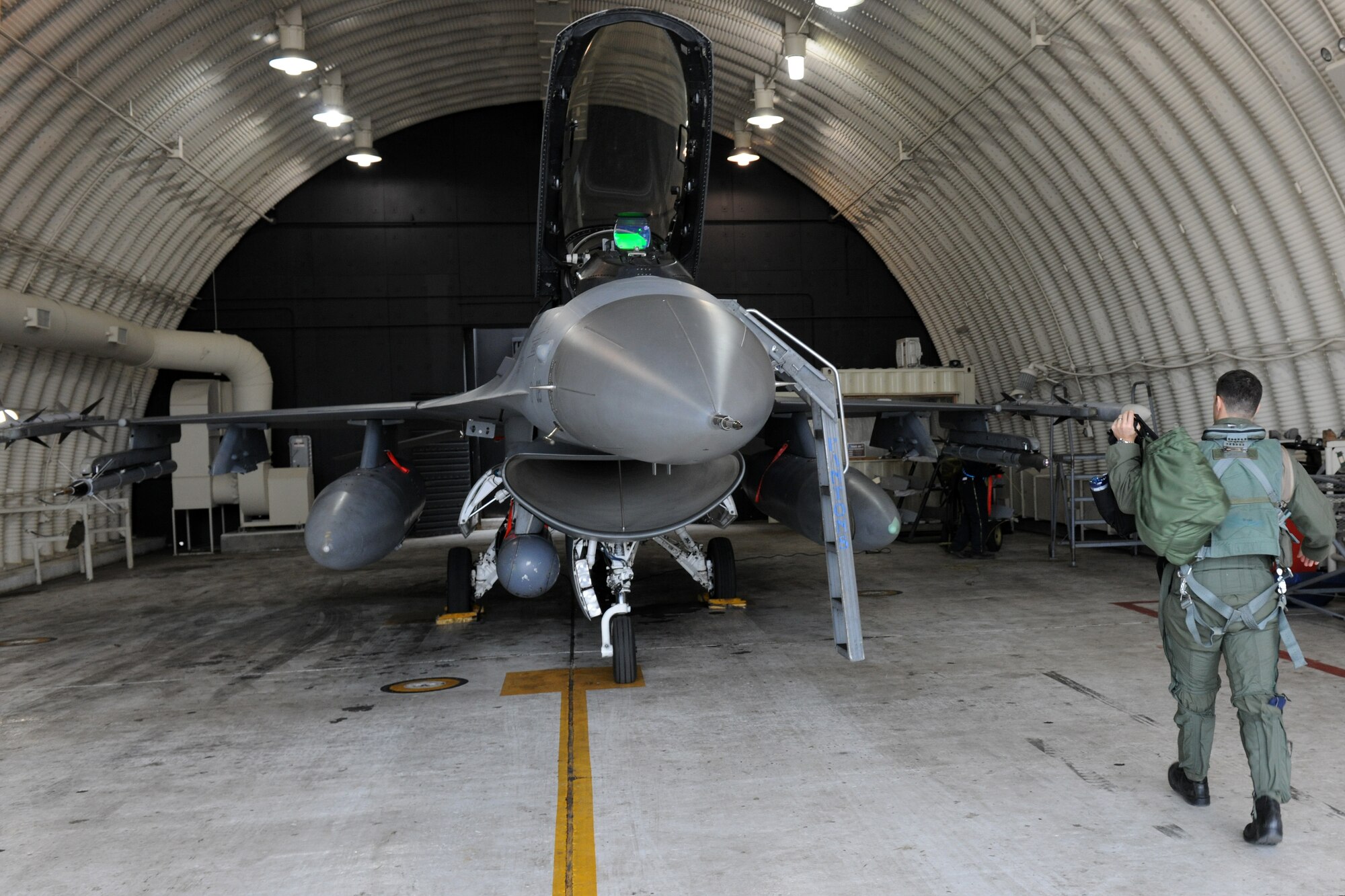 KUNSAN AIR BASE, Republic of Korea -- Capt. Mason Enright, 35th Fighter Squadron pilot, prepares for pre-flight checks of his F-16 Fighting Falcon aircraft and readies his equipment Feb. 10 before participating in a Combined Large Force Employment training exercise. The CLFE consists of four different units including the 35th FS, the 80th FS, Republic of Korea Air Force and the 36th FS based out of Osan AB, ROK. (U.S. Air Force photo/Tech. Sgt. Jonathan Pomeroy) 