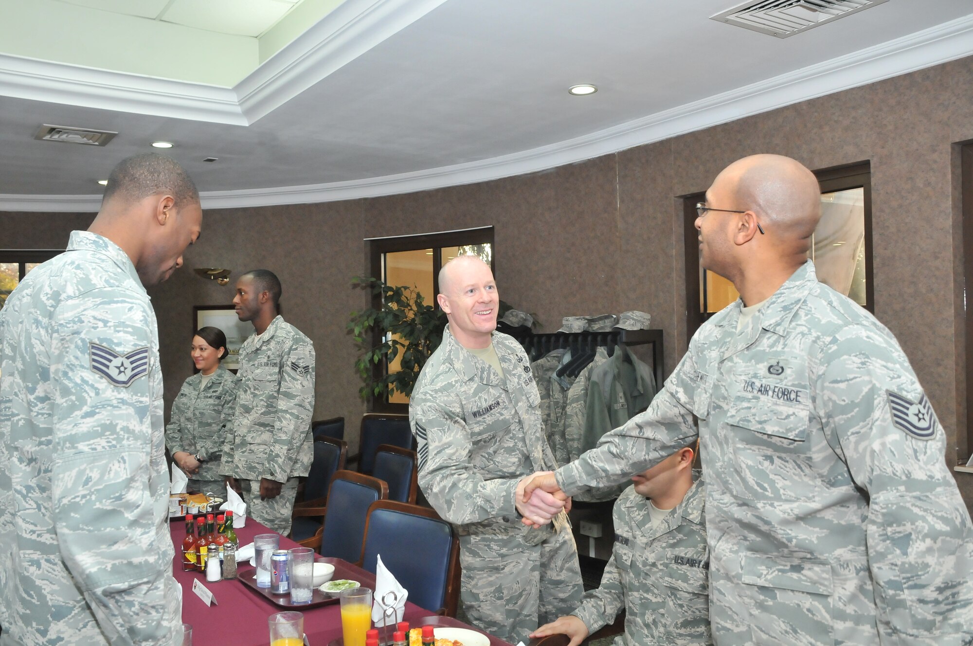 United States Air Forces in Europe Command Chief Master Sgt. David W. Williamson greets Tech. Sgt. Jason Hewitt of the 39th Operations Squadron during the Airmen’s breakfast, Feb. 3, 2011, at Incirlik Air Base, Turkey. This was an opportunity for Chief Williamson talk to Airmen working on Incirlik AB. As the USAFE command chief, he advises the commander on all matters affecting the readiness, training, professional development and effective utilization of the 36,000 assigned (is this the number of enlisted personnel in the command? If so, clarify that) personnel in the command. He also represents the USAFE enlisted force at a variety of conferences, forums and events. Gen. Mark A. Welsh III, the USAFE commander, also attended the breakfast. (U.S. Air Force photo by Staff Sgt. Alex Montes/released)