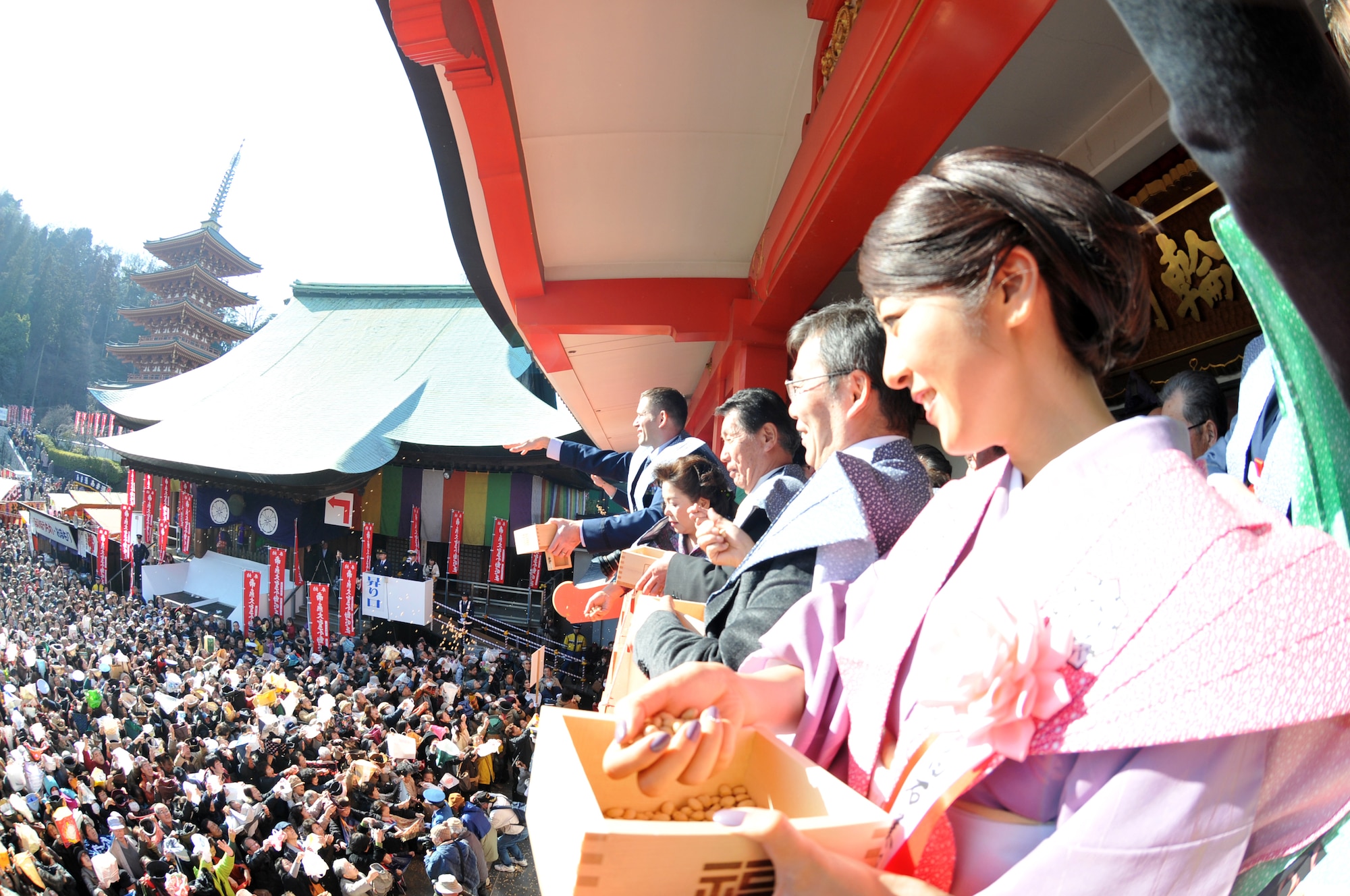 HINO CITY, Japan -- Hino City residents along with members from Yokota Air Base, Japan, throw roasted soy beans during the annual Bean Throwing Ceremony at Takahata Fudo Temple here Feb. 3. As the beans are thrown during the ceremony, the phrase "fu ku wa uchi" is shouted, which means "come in happiness". (U.S. Air Force photo/Airman 1st Class Krystal M. Garrett)   

