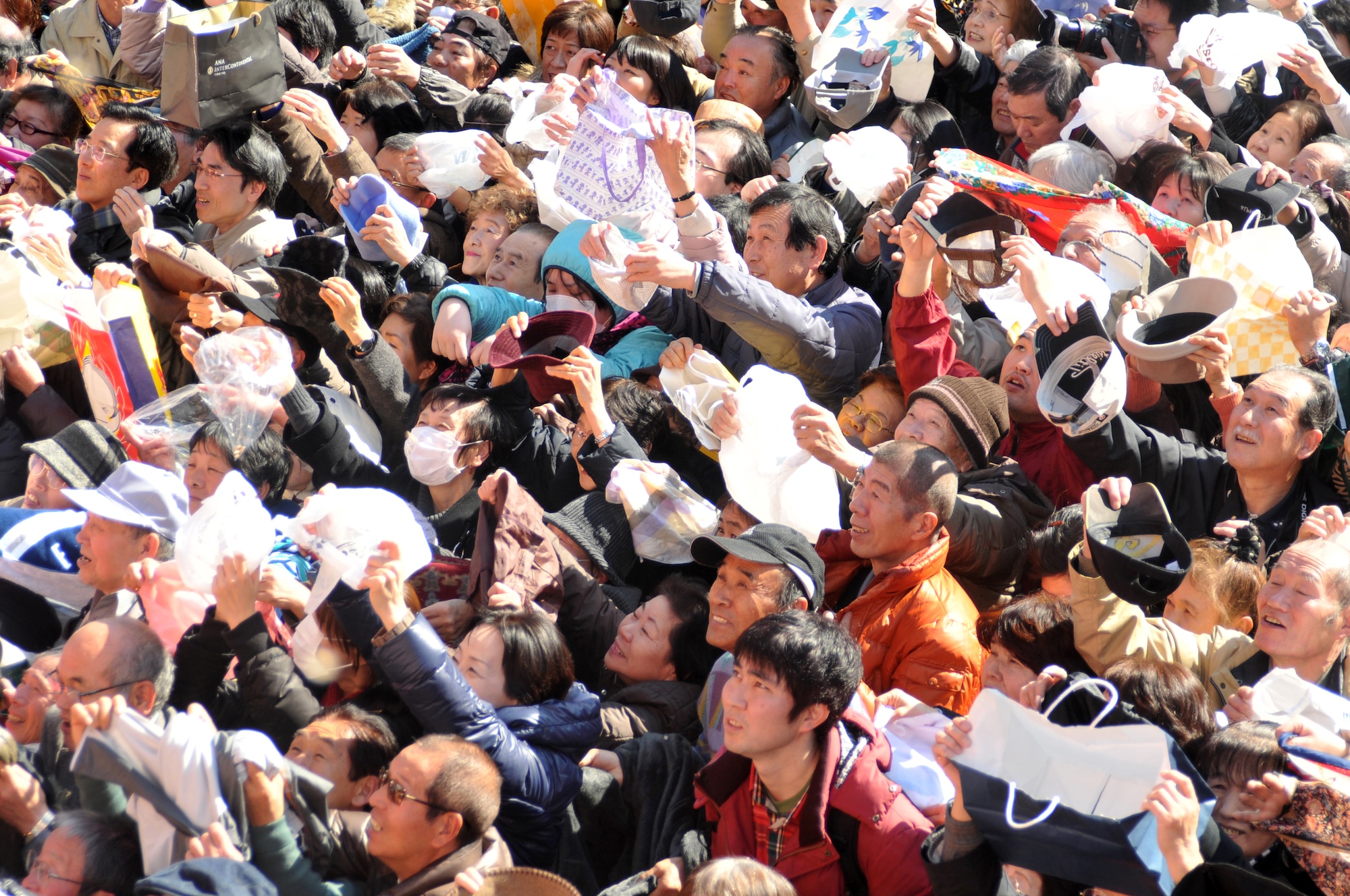 Hino City, Japan -- Attendees at the Bean Throwing Ceremony held in Hino City prepare to catch roasted soy beans at the Takahata Fudo Temple here Feb. 3. Tradition states that if a person eats the number of beans equal to their age they will have a happy and healthful life.  (U.S. Air Force photo/Airman 1st Class Krystal M. Garrett)  