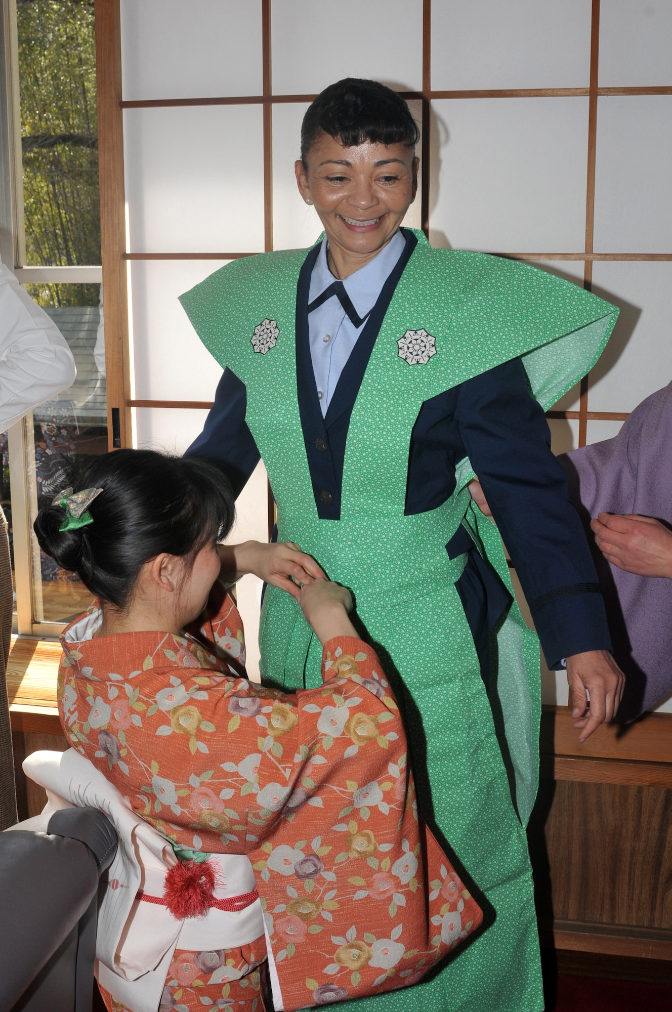 HINO CITY, Japan -- Lt. Col. Christine Taylor, 374th Surgical Operations Squadron commander, Yokota Air Base, Japan, dresses in "Kamishimo", a formal piece of clothing worn by a samurai or Japanese warrior, in preparation for the annual Bean Throwing Ceremony at Takahata Fudo Temple here Feb. 3. Personnel from Yokota have been participating in the ceremony for more than a decade. (U.S. Air Force photo/Airman 1st Class Krystal M. Garrett)