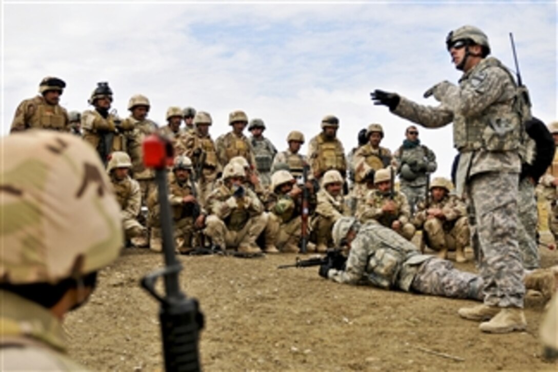 U.S. Army Sgt. Kevin Murphy (right) instructs Iraqi army soldiers on individual movement techniques during a class at the Ghuzlani Warrior Training Center, Iraq, on Feb. 2, 2011.  Murphy is assigned to the 1st Cavalry Division's 1st Squadron, 9th Cavalry Regiment, 4th Advise and Assist Brigade.  