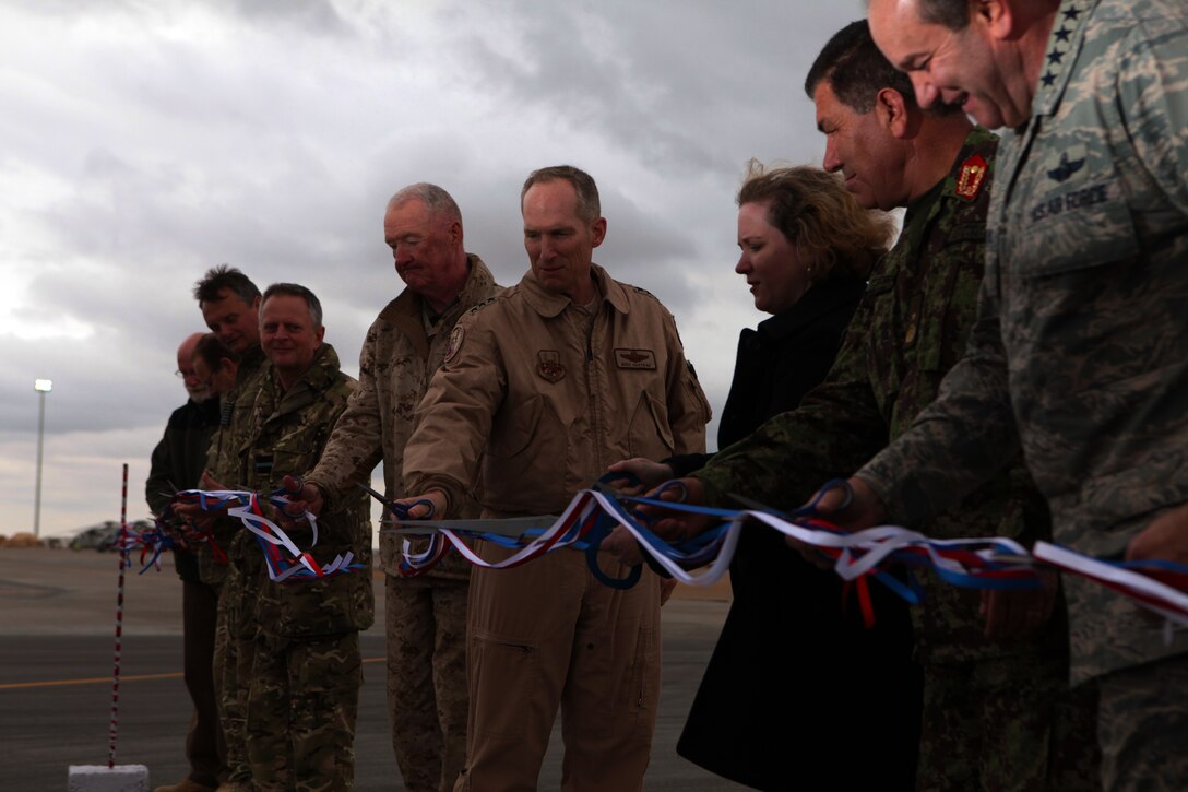 Top-ranking officials from all parties involved in the development of the new flightline aboard Camp Bastion cut the ribbon, which signified the official opening of the runway during the Camp Bastion flightline ribbon-cutting ceremony in Afghanistan Feb. 10.  The extensive three-year flightline project was a joint effort between Marines, sailors, airmen and local contractors.  The new 11,500-foot runway allows the joint camps of Bastion and Leatherneck to receive air traffic from larger aircraft, such as the C-5 Galaxy, Boeing 737 and Antonov AN-124 Condor.   Subsequently, it will assist in reducing the amount of civilian and military convoys traveling to and from Leatherneck and Bastion.  This will reduce the threat of roadside improvised explosive devices, as well as reduce the number of aircraft needed to transport large numbers of service members within the area of operations.  The previous 7,000-foot runway remains utilized as a taxiway for aircraft traveling to and from the airfield, while the new runway is now officially open for business.