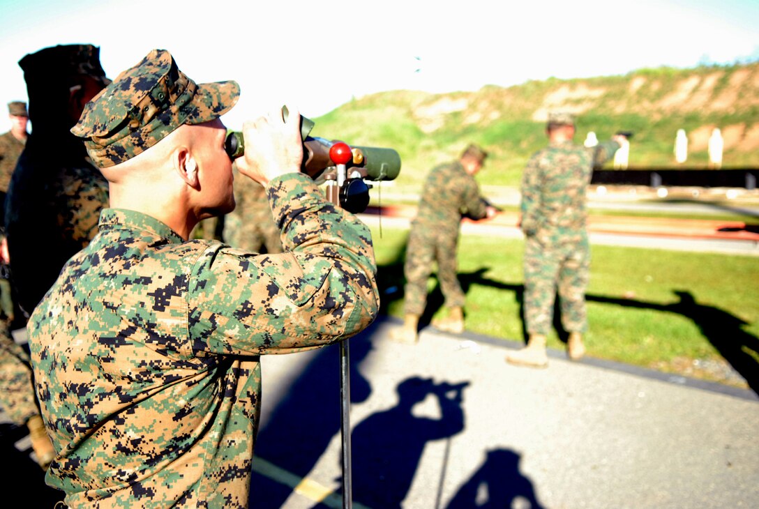 Sgt. Christopher Sanchez, drill instructor, checks out his target using a range spotting scope during the annual Depot Competition in Arms. The event, which lasts from Jan. 31 until Feb. 12, is held at Edson Range, Weapons Field Training Battalion, Camp Pendleton, Calif. The contest draws Marines from throughout the depot and the Western Recruiting Region.