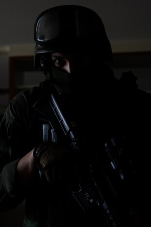 Lance Cpl. Michael Gallo, a station Special Reaction Team point man, stands ready to act during a training scenario at Building 906 here Feb. 10. The training allowed the team members to learn each other’s movements and enhance their ability to work together.