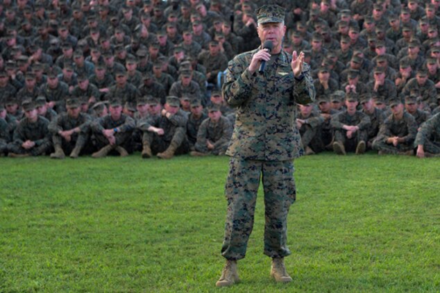 Gen. James F. Amos, 35th commandant of the Marine Corps, grins as Sgt. Maj. Carlton W. Kent, sergeant major of the Marine Corps, shares a story with approximately 2,000 Marines from 3rd Marine Regiment during a visit to Marine Corps Base Hawaii, Feb. 10, 2011. During their visit, the leaders spoke about and answered questions concerning the Corps’ continued involvement in overseas operations, reduction in personnel, the future of certain military occupational specialties, and issues surrounding the recent repeal of the Department of Defense’s “Don’t Ask, Don’t Tell” policy. For Amos, who began his career as a first lieutenant with a Hawaii-based squadron, the visit to Hawaii was his first as commandant.
