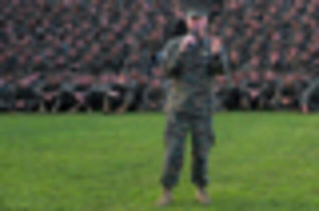 Gunnery Sgt. Christopher Denham, company gunnery sergeant, Company I, 3rd Battalion, 3rd Marine Regiment, stands at parade rest and clutches a coin from Gen. James F. Amos, 35th commandant of the Marine Corps, as he listens to Amos answer his question during his visit to Marine Corps Base Hawaii, Feb. 10, 2011. During Amos’ visit, he and Sgt. Maj. Carlton W. Kent, sergeant major of the Marine Corps, spoke about and answered questions concerning the Corps’ continued involvement in overseas operations, reduction in personnel, the future of certain military occupational specialties, and issues surrounding the recent repeal of the Department of Defense’s “Don’t Ask, Don’t Tell” policy. For Amos, who began his career as a first lieutenant with a Hawaii-based squadron, the visit to Hawaii was his first as commandant.
