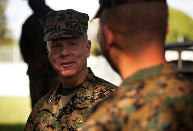Gen. James F. Amos, 35th commandant of the Marine Corps, speaks with Col. James Bierman, commanding officer, 3rd Marine Regiment, after speaking to a crowd of approximately 2,000 Marines from the regiment during a visit to Marine Corps Base Hawaii, Feb. 10, 2011. During Amos’ visit, he and Sgt. Maj. Carlton W. Kent, sergeant major of the Marine Corps, spoke about and answered questions concerning the Corps’ continued involvement in overseas operations, reduction in personnel, the future of certain military occupational specialties, and issues surrounding the recent repeal of the Department of Defense’s “Don’t Ask, Don’t Tell” policy. For Amos, who began his career as a first lieutenant with a Hawaii-based squadron, the visit to Hawaii was his first as commandant.