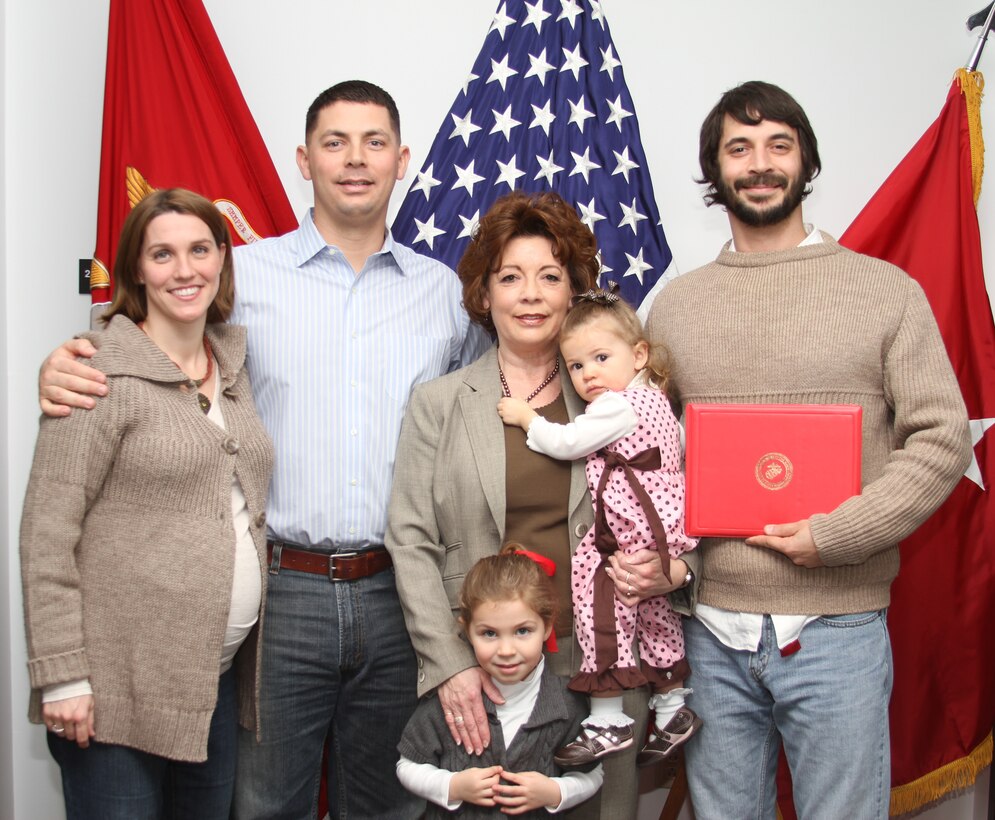 Elizabeth Montalvo (center), deputy assistant chief of staff G-1, Marine Corps Recruiting Command, is joined by her family Feb. 11, 2011 after being awarded the Navy Meritorious Civilian Service medal. Montalvo’s son, Maj. Eric Montalvo (pictured second left), will be joining II Marine Expeditionary Force for their upcoming deployment to Afghanistan.