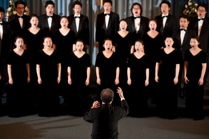 NELLIS AIR FORCE BASE, Nev. --  Chai Hoon-Cha, Korean Students Glee Club conductor, conducts the glee club choir during a performance at the base chapel Feb. 10. The Korean Students Glee Club is on tour throughout the United States and Canada until Feb. 23, 2011. The Glee Club was established in 1966 and is composed of college students studying music in various universities in the Seoul metropolitan area. (U.S. Air Force photo by Tech. Sgt. Michael R. Holzworth)
