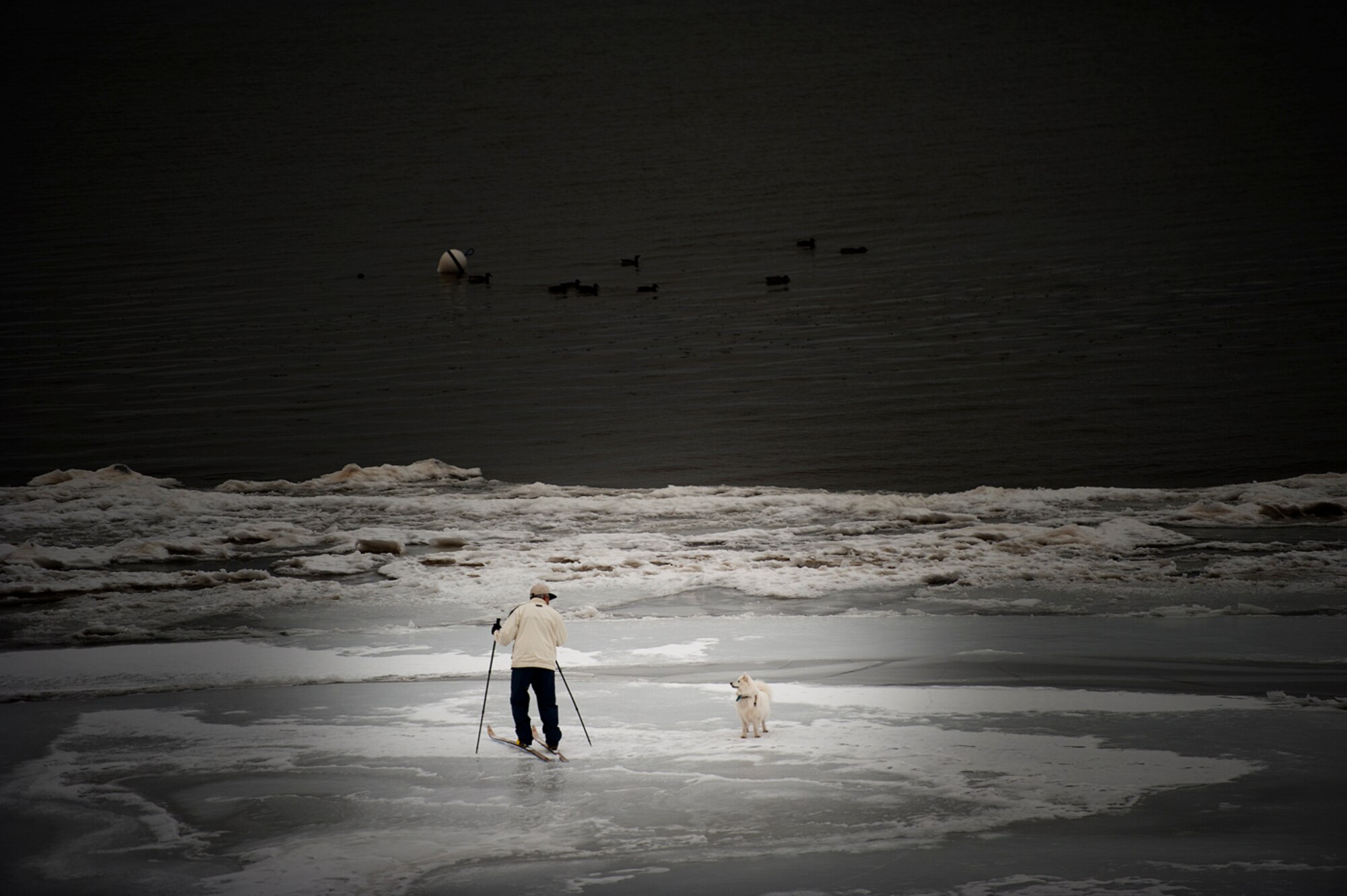 A cross country skier is warned by his loyal companion to turn around while crossing the partially frozen waters of Lake Tahoe.
(Photo by TSgt Samuel Bendet)