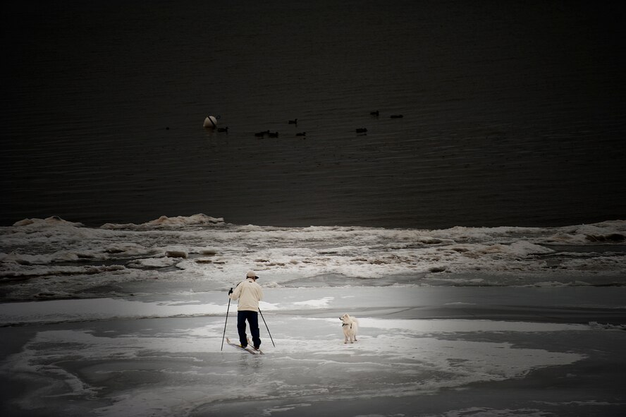 A cross country skier is warned by his loyal companion to turn around while crossing the partially frozen waters of Lake Tahoe.
(Photo by TSgt Samuel Bendet)