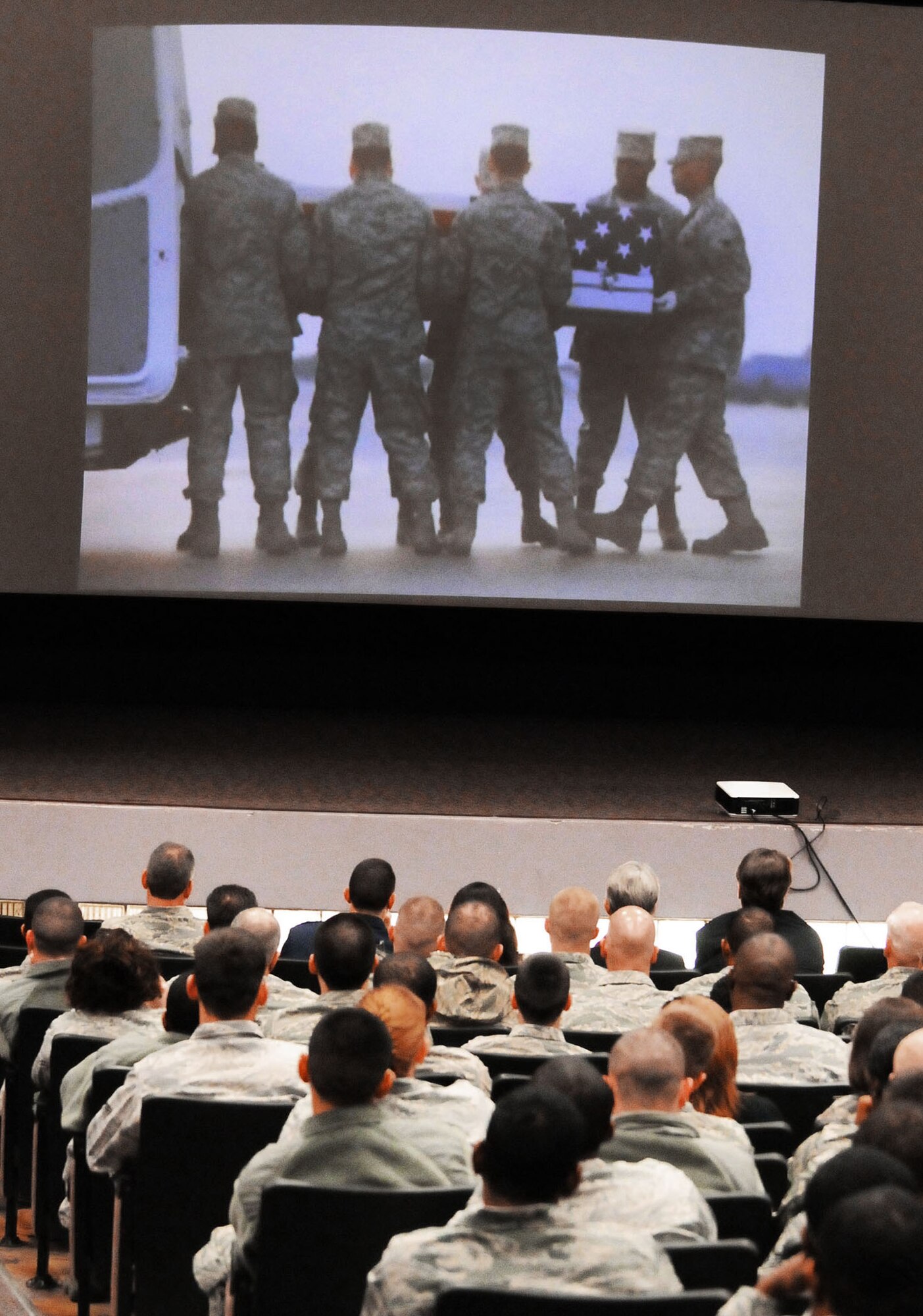 Members of the 5th Combat Communications Group view slides of the dignified transfer of Airman 1st Class Austin Gates-Benson. Airman Gates-Benson served with the 54th CBCS. (U.S. Air Force photo/Sue Sapp) 
