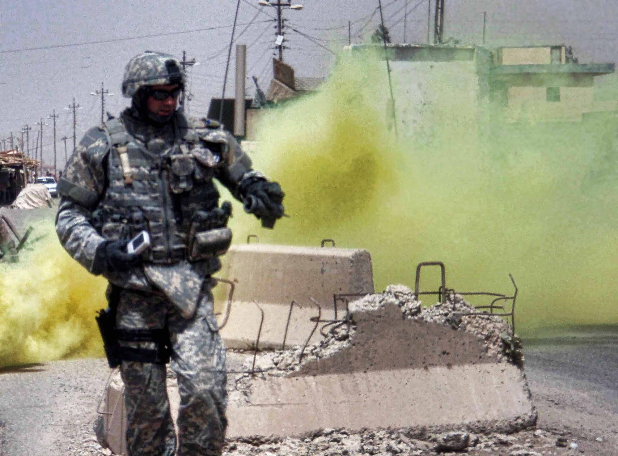 Tech. Sgt. Benjamin Horton responds to an attack on a security checkpoint July 7, 2007, in Kirkuk, Iraq. Due to , Sergeant Horton used a smoke screen to provide cover from rocket and sniper fire. He was able to quickly neutralize several rockets that had failed to detonate. Sergeant Horton is a 775 Civil Engineer Sqadron Explosive Ordnance Disposal Flight team leader. (U.S. Air Force photo/Staff Sgt. Glenn Henthorn)     
