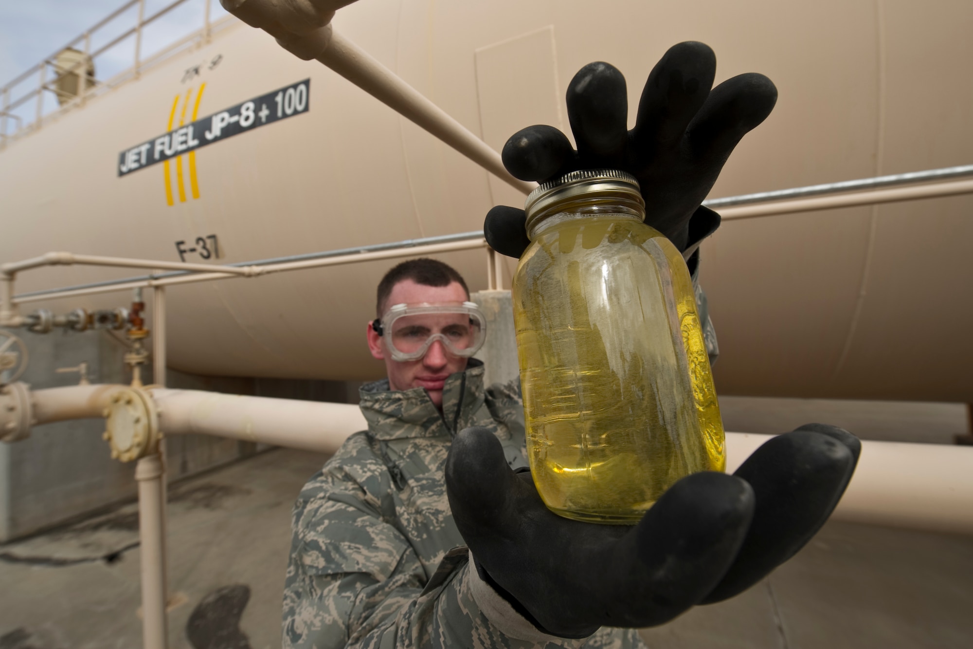 HOLLOMAN AIR FORCE BASE, N.M. -- Airman Guy Peterson, 49th Fuels Management Flight, visually inspects a sample of  JP-8 jet fuel at the base's west hydrants facilities, Feb. 9, 2011. Airman Peterson is checking the color, water and sediment to ensure the fuel coming into the fuel pipe is visually clean. (U.S. Air Force photo by Airman 1st Class Joshua Turner/Released)
