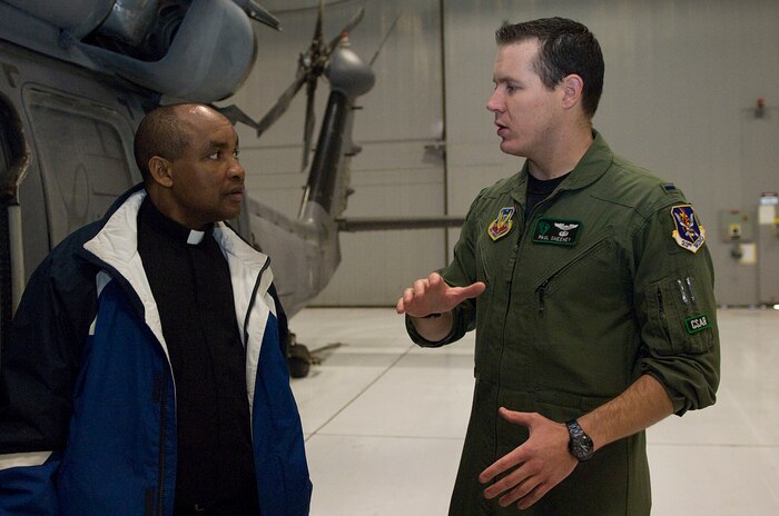 NELLIS AIR FORCE BASE, NEV.-- 1st Lt. Paul Sheehey, 66th Rescue Squadron HH-60G Pave Hawk helicopter pilot, speaks with Rev. Livingstone Peshu Feb 10. The Chaplain's Recruiting program allows individuals interested in becoming chaplains for the U.S Air Force to visit the base and experience daily operations. (U.S Air Force photo by Senior Airman Stephanie Rubi / Released) 
