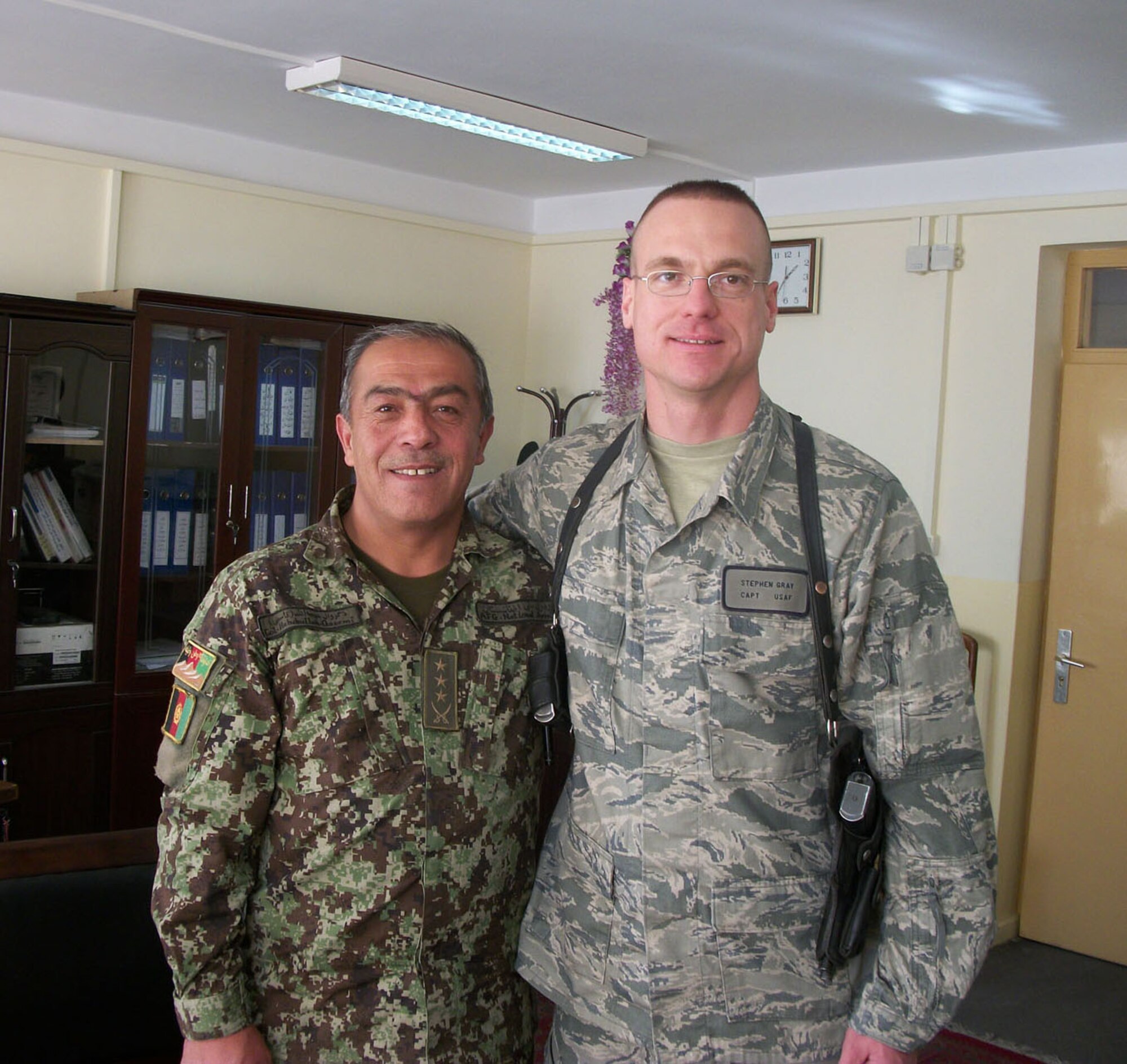 Capt. Stephen Gray (right), who served as an advisor to the Afghan National Army Acquisition Agency during a recent deployment to Afghanistan, stands with Col. Qaseemi Habibullah, from Afghanistan’s Central Contracting Directorate. Captain Gray fulfilled a non-traditional role by mentoring Colonel Habibullah and others while helping lead the transition in Afghanistan. (Courtesy photo)