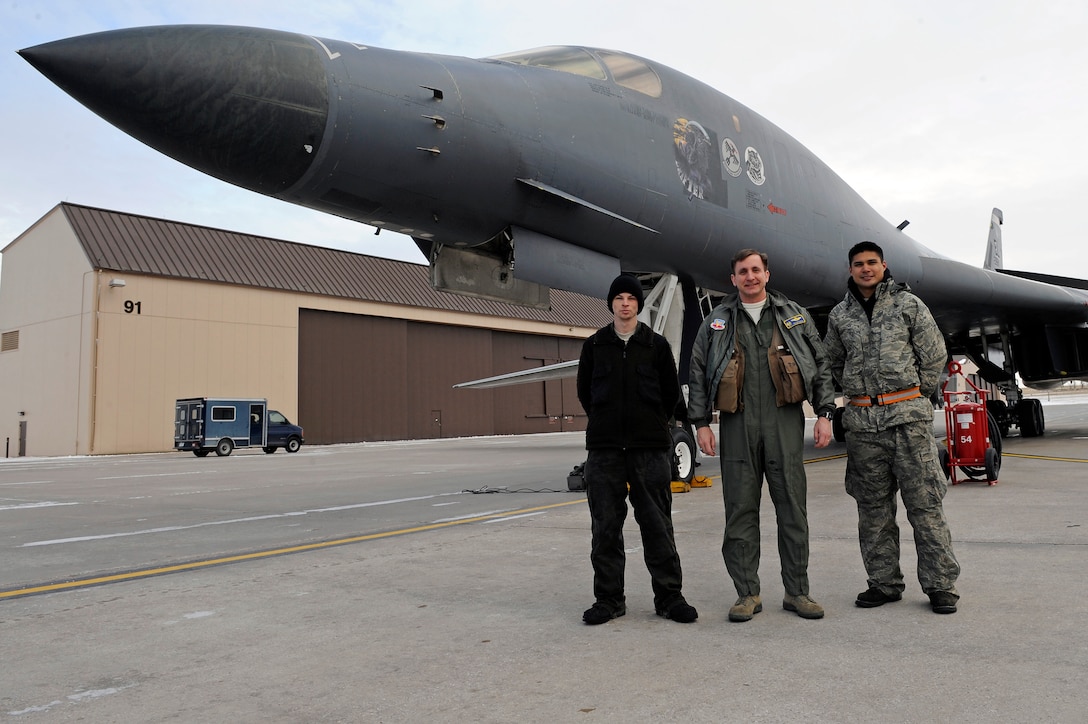 (Center) Col. Jeffrey Taliaferro, 28th Bomb Wing commander, stands with (left) Airman 1st Class Trent Murphy and Senior Airman Kevin Faulds in front of the wing’s flagship B-1B Lancer on Ellsworth Air Force Base, S.D., Feb. 10, 2011.  Airmen Murphy and Faulds are both crew chiefs assigned to the 34th Bomb Squadron. (U.S. Air Force photo/Staff Sgt. Marc I. Lane)
