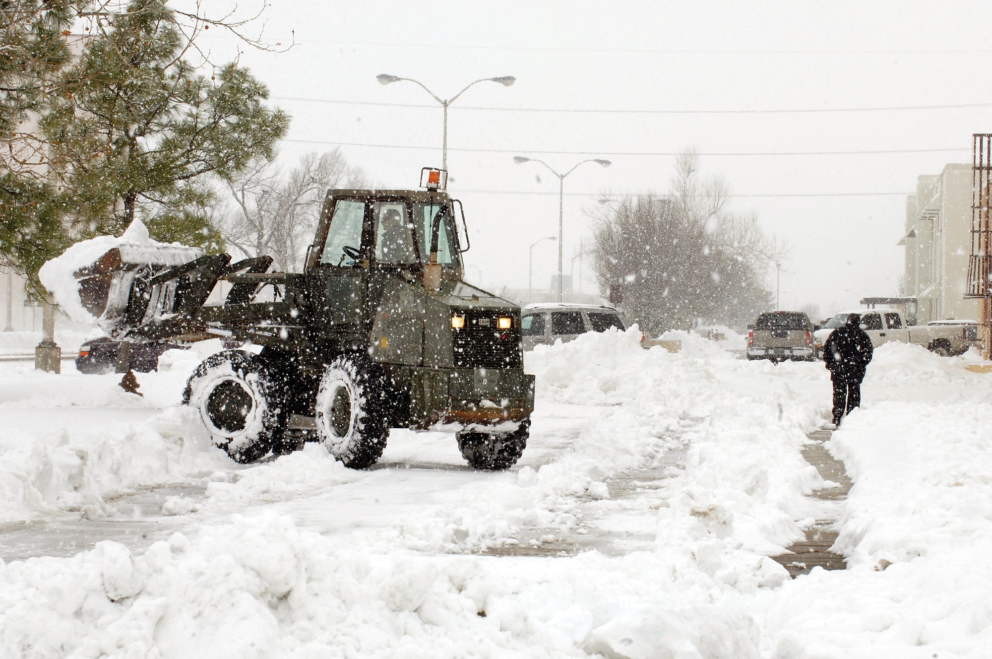 The 72nd Air Base Wing Civil Engineer Directorate’s Joe Eason uses a front-loader to clear snow from a Tinker parking area Feb. 4. Mr. Eason was one of 14 CE members, including two mechanics, who worked around the clock to clear snow from Tinker roads and parking areas from two winter storms. Another crew worked to keep airfield ramps and runways cleared. It took a true team effort to get the base up and running. (Air Force photo by Margo Wright)