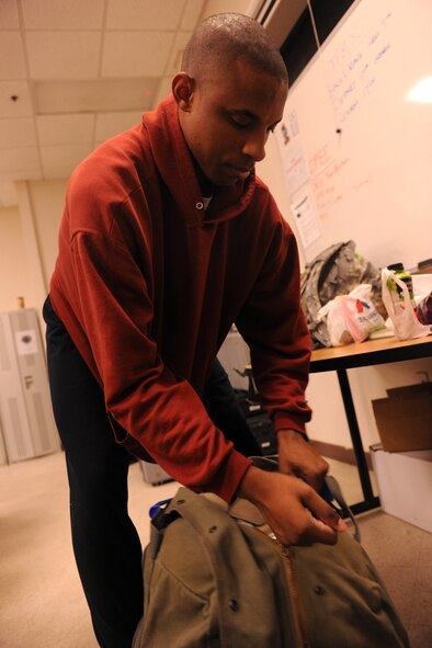MOODY AIR FORCE BASE, Ga. -- Senior Airman Deandre Greer, 823rd Base Defense Squadron fire team member, does a final check on his gear before loading a bus to travel to a joint forces exercise at Fort Bragg, N.C., Feb. 10. More than 30 security forces personnel from the 823rd BDS will be participating in the three-day exercise. (U.S. Air Force photo/Airman 1st Class Benjamin Wiseman)(RELEASED)