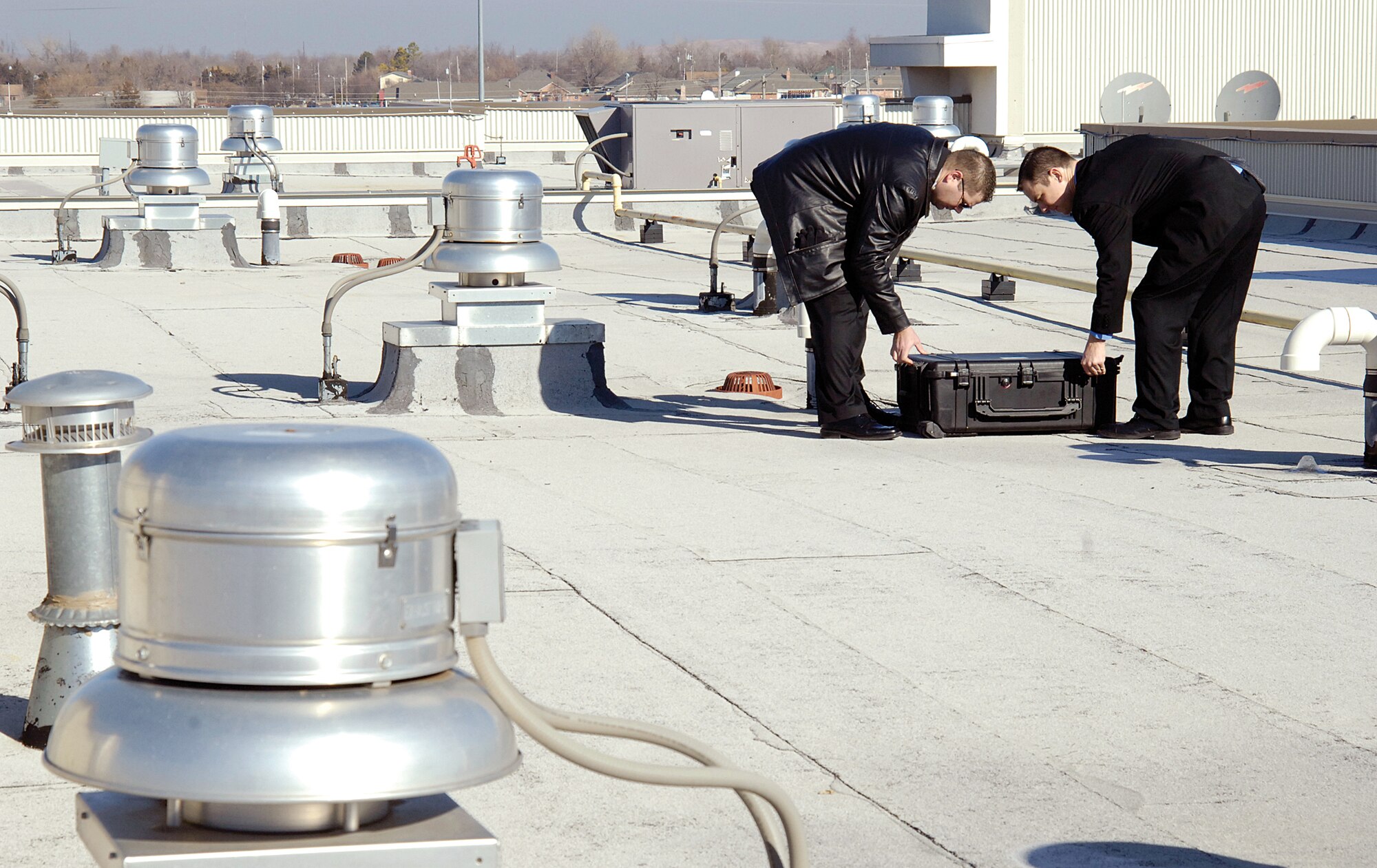 During training at a local hotel, Staff. Sgts. Anthony Luckert, left, and Benjamin Murphy, unpack an antenna, or “zilch” kit. The men are protective communications specialists and support the 31st Combat Communications Squadron’s special mission supporting the Secret Service. (Air Force photo by Margo Wright)