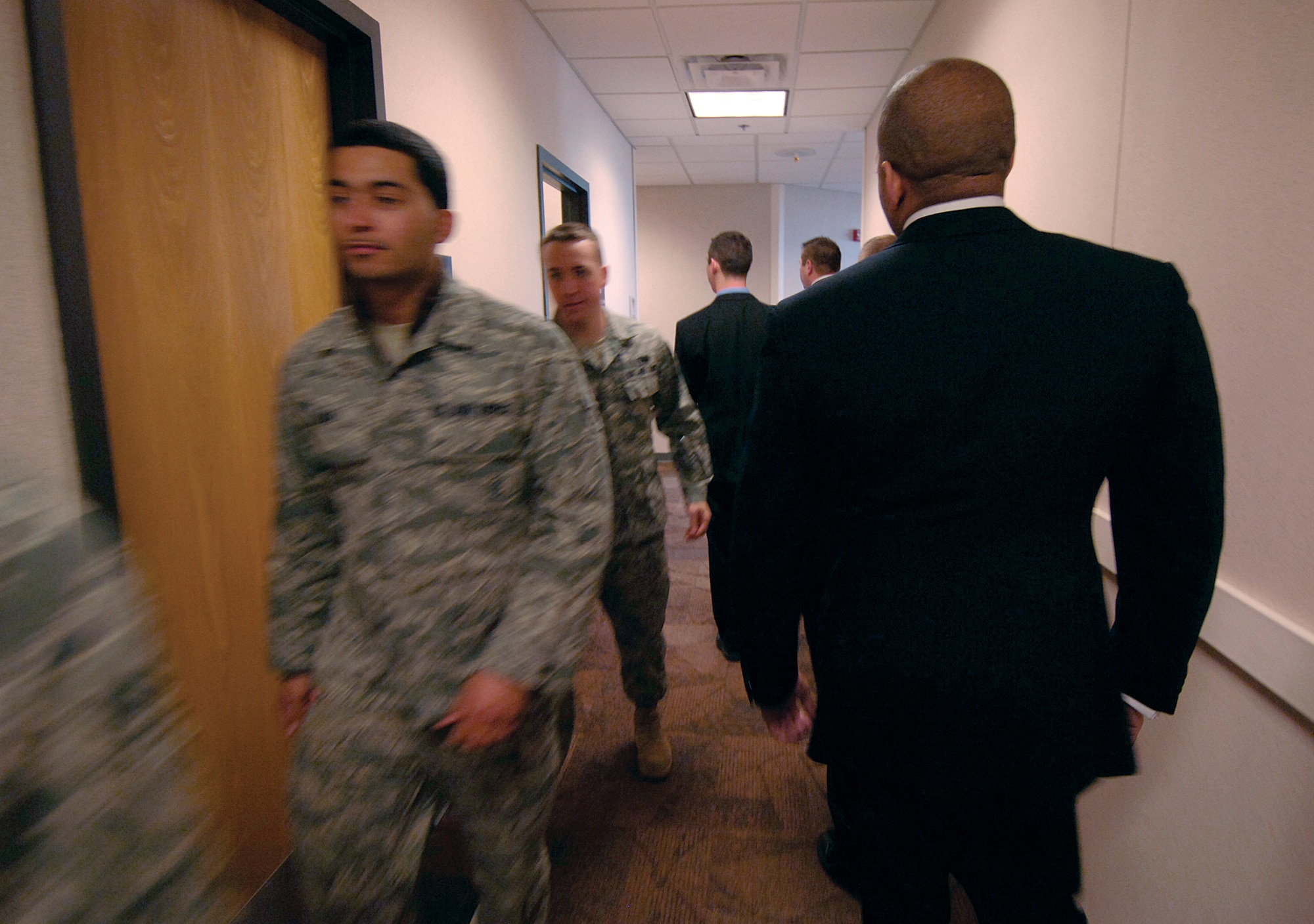 Members of the 31st Combat Communications Squadron’s Secret Service mission stand out in their civilian attire as they move through the squadron’s hallways.  The team of five was hand-picked for the squadron’s mission that aids the Secret Service with communications support as they provide protection for former U.S. presidents and their families, presidential candidates, foreign heads of state and for specified major events. (Air Force photo by Margo Wright)