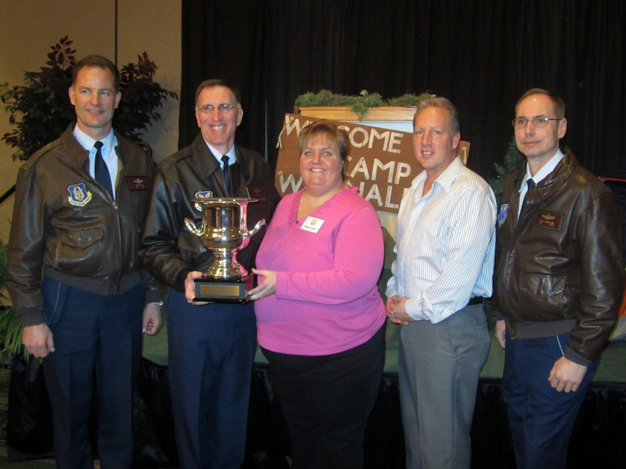 OSAGE BEACH, Mo. - Col. Eric Overturf, 442nd Fighter Wing commander; Brig. Gen. Scott Vander Hamm, 509th Bomb Wing commander; Mr. Greg Hauser, 509th FSS community services flight and Col. Gregory Champagne, 131st Bomb Wing commander accept the Award of Excellence trophy from Diane Brimer, Central Area Director of Special Olympics Missouri the SOMO annual awards luncheon Jan. 15. (Courtesy photo)                