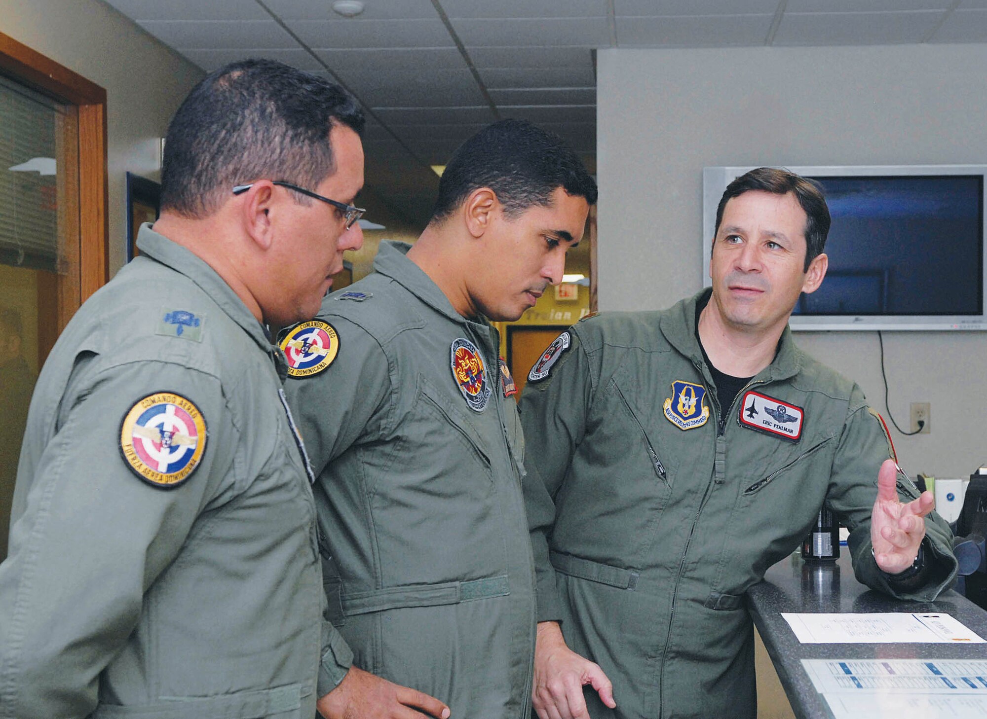 Maj. Eric Perlman, 69th Fighter Squadron assistant director of operations, explains to Dominican Republic officers the squadron flight schedule on February 3rd during their visit to Luke Air Force Base, Arizona.  (U.S. Air Force photo/Senior Airman Darlene Seltmann)