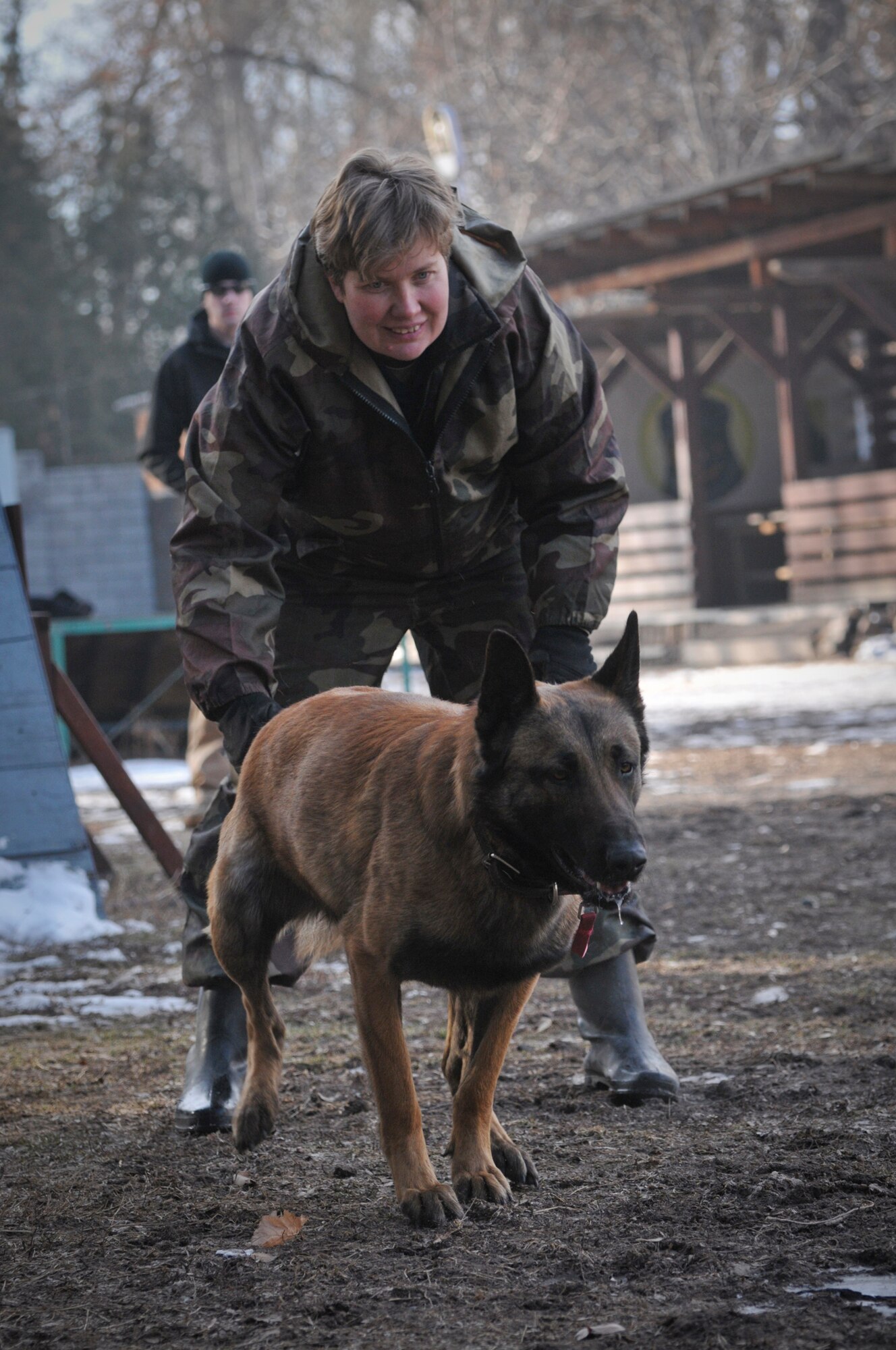 TRANSIT CENTER AT MANAS, Kyrgyzstan -  A member of Bakyt National Security releases her dog to a U.S Military trainer in a bite suit as a part of a military to military information exchange Feb. 11. K-9 members from the Transit Center here train with Kyrgyz military members in order to learn from each other and foster good working relationships. (U.S. Air Force photo/Staff Sgt. Stacy Moless)