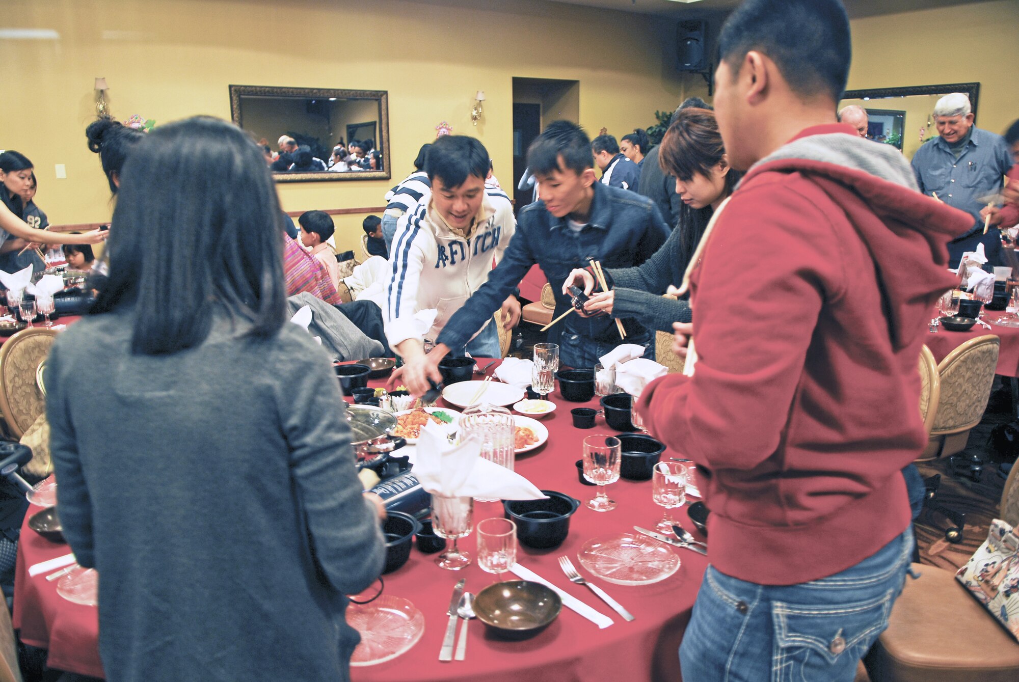 Servicemembers and family members from the 425th Fighter Squadron participate in the Law Yu Sheng ceremony on February 2nd during the Chinese New Year celebration held at the Club Five Six at Luke Air Force Base, Arizona.  Law Yu Sheng is a salad dish made with slices of raw fish and various spices.  (U.S. Air Force photo/Airman David Owsianka)