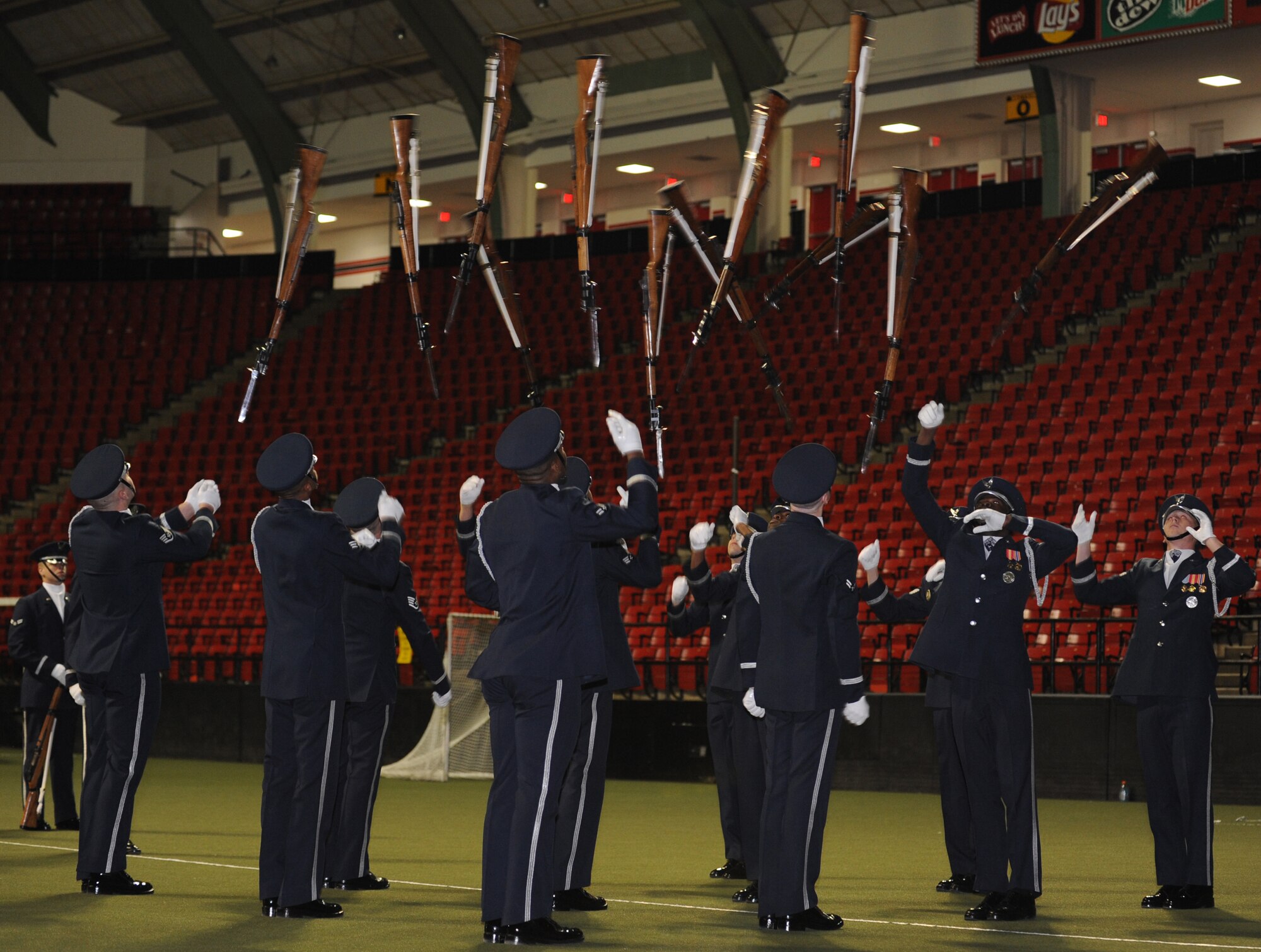 Members of The U.S. Air Force Honor Guard drill team toss their rifles Feb. 10 at the University of Maryland University Campus, College Park, Md. The performance showcases the precision and dedication the Air Force has in day-to-day missions.  (U.S. Air Force photo by Senior Airman Christopher Ruano)