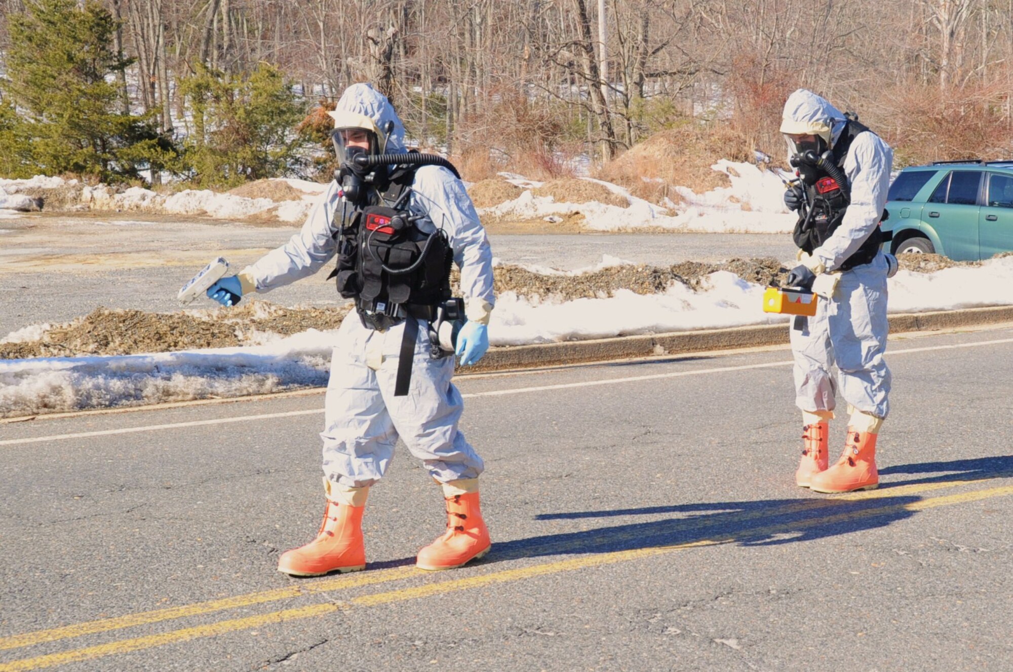 Senior Airman Daniel Jackson and Senior Airman Jordan Stipcak, 87th Civil Engineer Squadron emergency managers, sweep the ground for contaminants after a chemical, biological, radiological, nuclear exercise at Joint Base McGuire-Dix-Lakehurst. The 87th CES Emergency Management Flight won the Air Force Emergency Management Flight of the Year award for the third time since 2002. (U.S. Air Force photo /Airman 1st Class Bryan Swink)