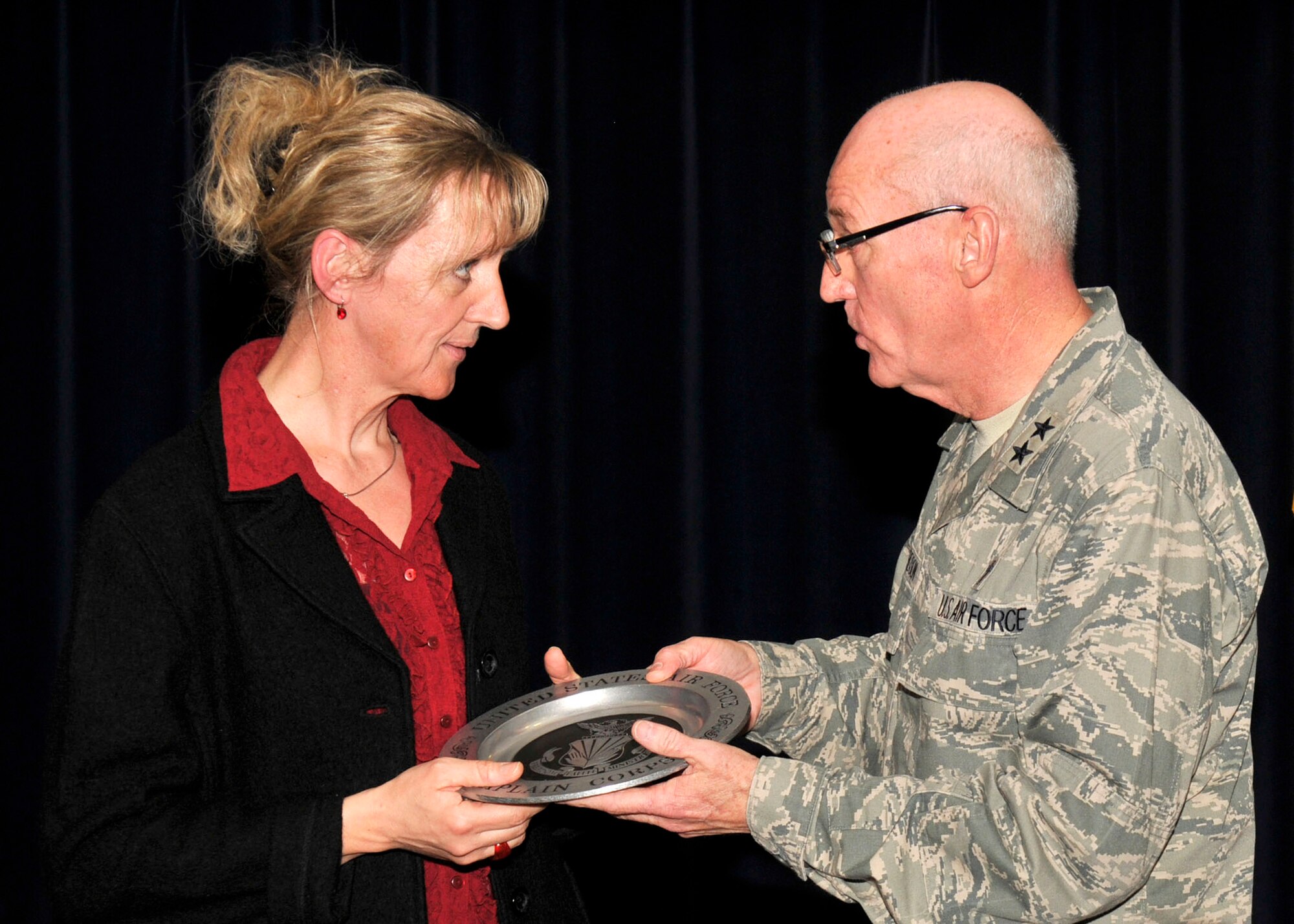 SPANGDAHLEM AIR BASE, Germany—Chaplain (Maj. Gen.) Cecil Richardson, Air Force chief of chaplains, presents Frau Birgit Schuh with a peuter plate for her 25 consecutive years of organizing the National Prayer Luncheon here Feb. 10 at Club Eifel. The National Prayer Luncheon is held annually to gather people together and focus on the importance of spiritual values in our pursuit of the nation’s welfare and defense of its way of life. (U.S. Air Force photo/ Airman 1st Class Brittney Frees)