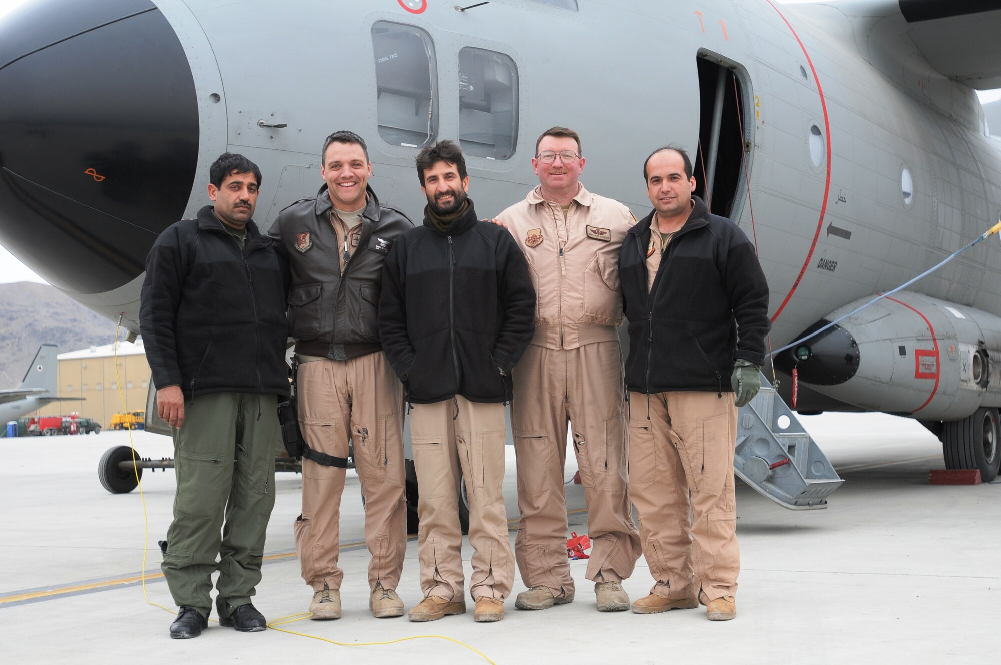 The crew for the milestone-breaking flight that brought the total number of hours flown for the Afghan Air Force in the C-27A Spartan aircraft past 2,000 hours poses for a photograph after landing on the Afghan Air Force Base in Kabul Feb 10. (U.S. Navy photo by Mass Communications Specialist 2nd Class Vladimir Potapenko). 