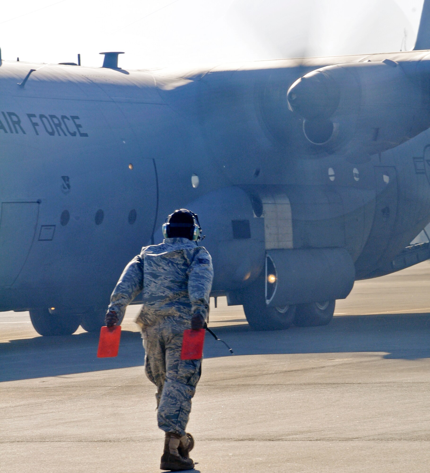 YOKOTA AIR BASE, Japan -- Staff Sgt. Shuan Stallworth, 374th Aircraft Maintenance Squadron crewchief, marshals a C-130 Hercules prior to take off from Yokota here Feb. 3. The aircraft is deploying to Andersen Air Base, Guam, in support of the annual Cope North exercise. (U.S. photo/Airman 1st Class Krystal M. Garrett)