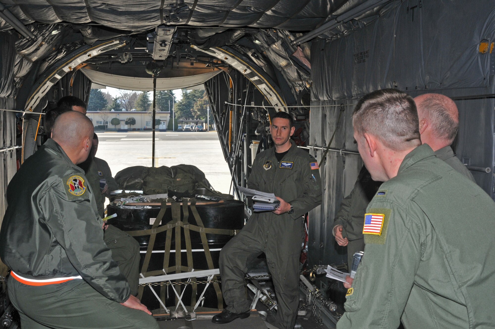 YOKOTA AIR BASE, Japan -- Capt. Matt Taylor, 374th Operations Group, briefs C-130 Hercules crew members here Feb. 3, prior to departure to Andersen Air Base, Guam, in support of the annual Cope North exercise. Pre-mission briefings are provided to ensure that everyone onboard the aircraft is aware of the expectations during the mission. (U.S. Air Force photo/Airman 1st Class Krystal M. Garrett) 