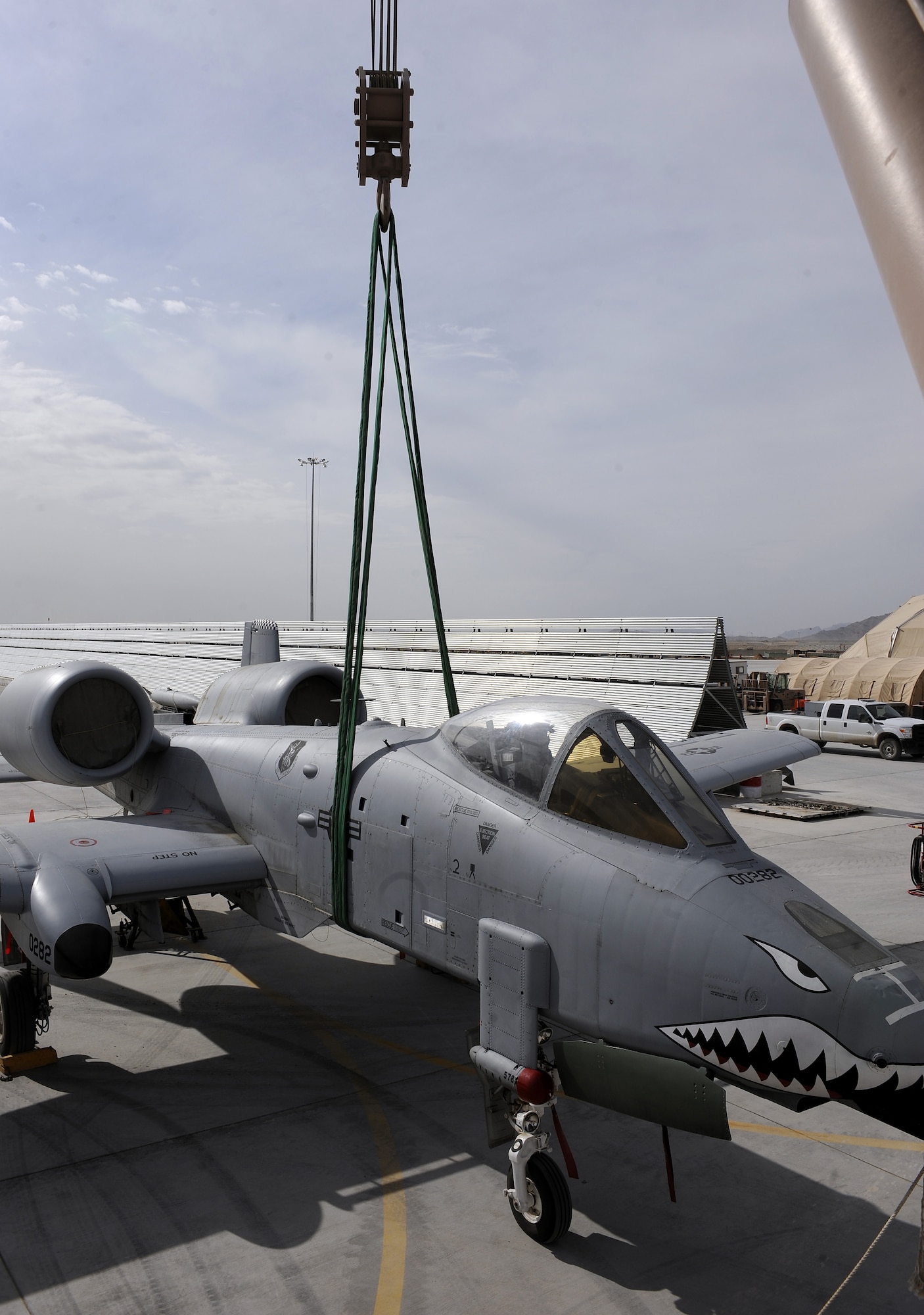 Staff Sgt. Nicholas Blucker prepares to hoist an A-10C Thunderbolt with a 60 ton crane during a lift exercise Feb. 9, 2011, at Kandahar Airfield, Afghanistan. The 451st Air Expeditionary Wing?s crash recovery team is responsible for all American aircraft with in-flight emergencies on the airfield. Sergeant Blucker is a crash recovery technician assigned to the 451st Expeditionary Maintenance Squadron. (U.S. Air Force photo/Senior Airman Willard E. Grande II/Released)