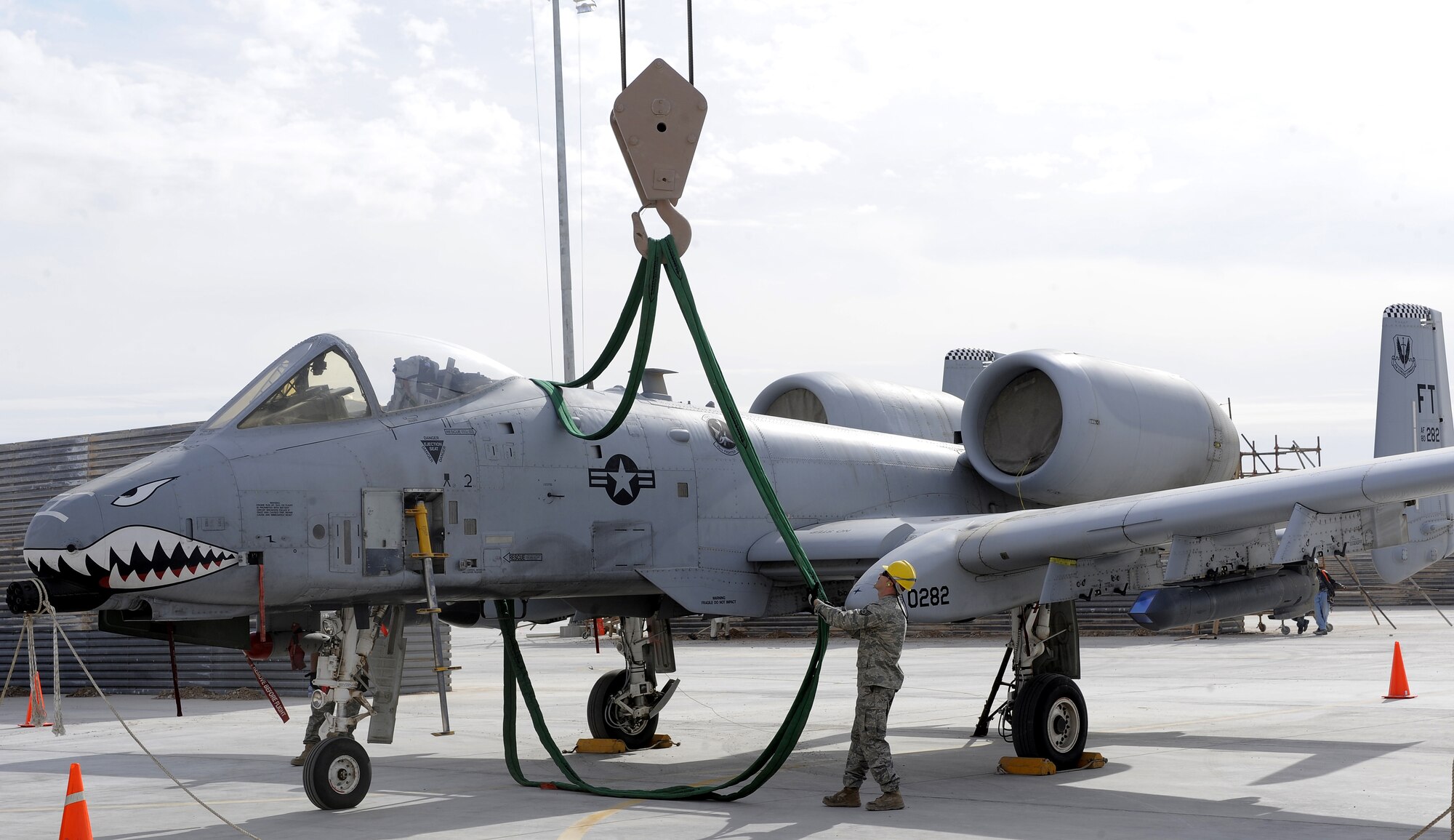 Staff Sgt. David Cook positions an aircraft sling for a lift exercise Feb. 09, 2011, at Kandahar Airfield, Afghanistan. A handful of crash recovery personnel work with Phase crew chiefs to quickly and safely respond to all American aircraft with in-flight emergencies on the airfield. Sergeant Cook is an A-10 phase technician assigned to the 451st Expeditionary Maintenance Squadron. (U.S. Air Force photo/Senior Airman Willard E. Grande II/Released)