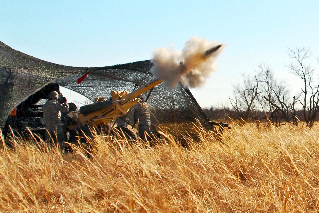 U.S. Army soldiers fire a 105 mm round from an M119 Howitzer on Fort Sill, Okla., Jan, 29, 2011.