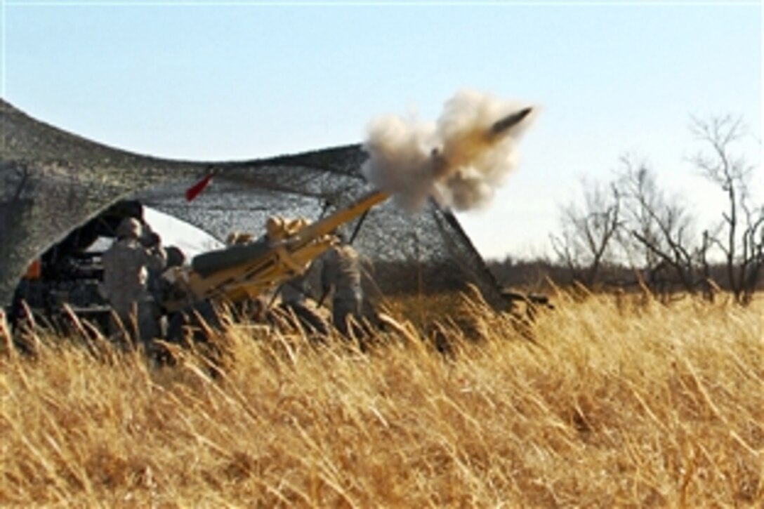 U.S. Army soldiers fire a 105 mm round from an M119 Howitzer during Operation Diamond Freeze, a combined forces, live-fire training exercise on Fort Sill, Okla., Jan. 29, 2011. 