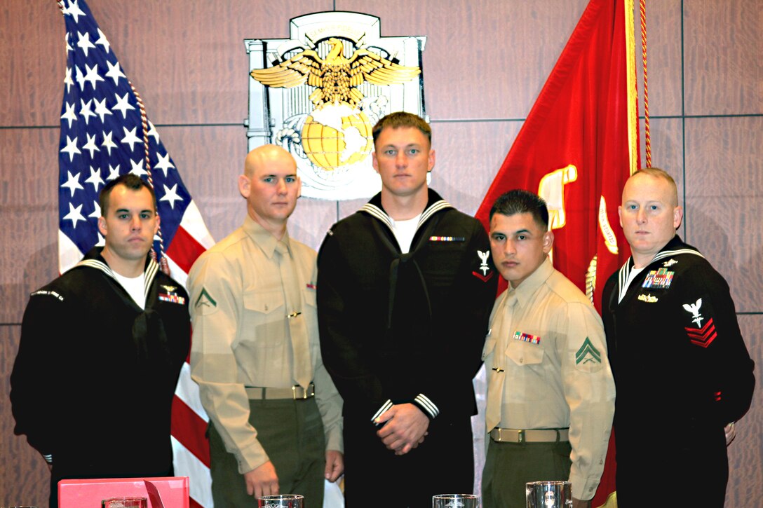 (From left to right) Bluejacket Sailor of the Quarter Seaman Matthew Rol, Branch Medical Clinic recruit health corpsman; Marine of the Quarter Lance Cpl. Zachary Stewart, weapons field range coach; Junior Sailor of the Quarter Petty Officer Third Class Andrew Johnson, BMC company corpsman, Noncommissioned Officer of the Quarter Cpl. Christopher E. Ramos, Headquarters and Service Battalion integrated management maintenance specialist; and Senior Sailor of the Quarter, Petty Officer First Class Brian Simpson, recruit processing leading petty officer. The Marines and sailors received awards for their achievements. To be recognized as a Marine or sailor of the quarter, the individual must stand out above their peers.