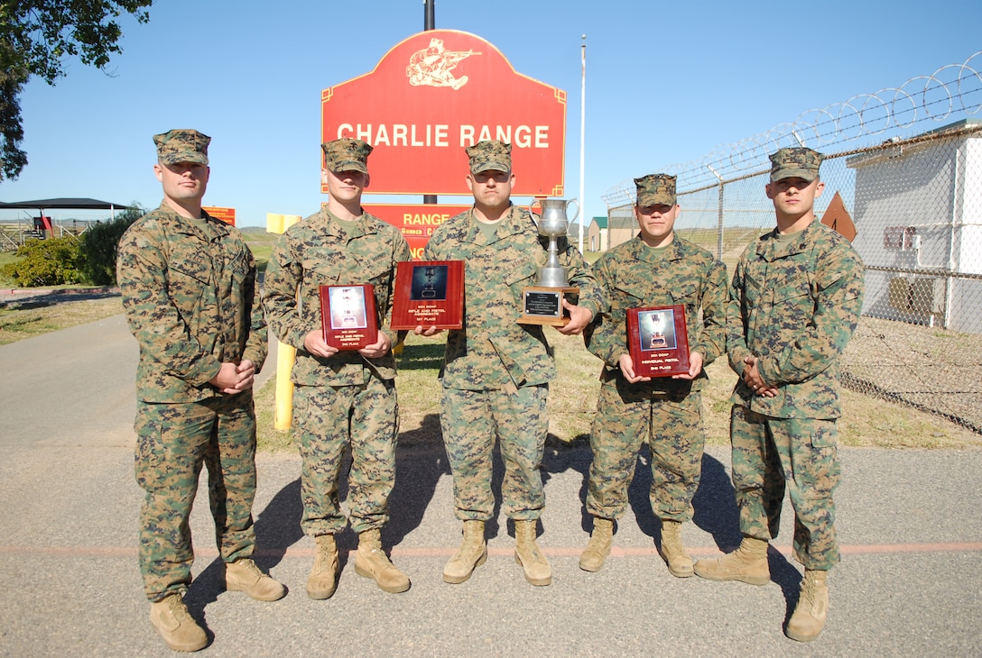 The 8th Marine Corps District shooters pose after receiving their awards. They proudly show off their award from coming in third for the pistol team match, ninth for the rifle team match, and fourth for the Gunner’s Match.