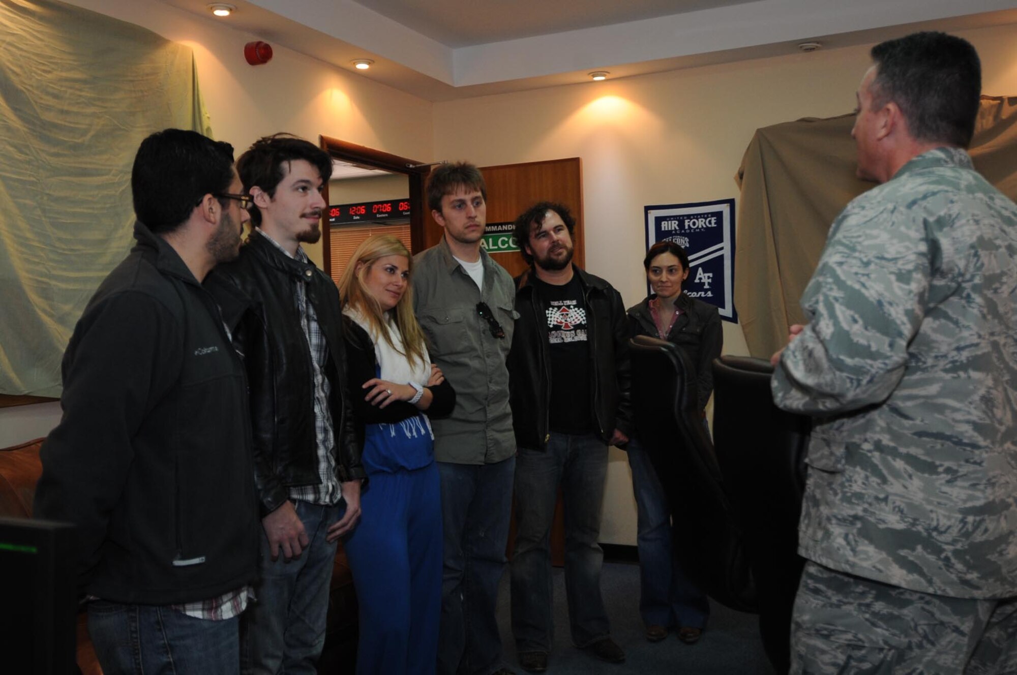 Members of the Boston-based band, Three Day Threshold, visits with Col. Patrick Mordente, 386th Air Expeditionary Wing commander, during their visit to The Rock Feb. 9. The band met with Airmen and put on a concert as part of  their Armed Forces Entertainment tour. (U.S. Air Force photo by Senior Airman Cynthia Spalding)