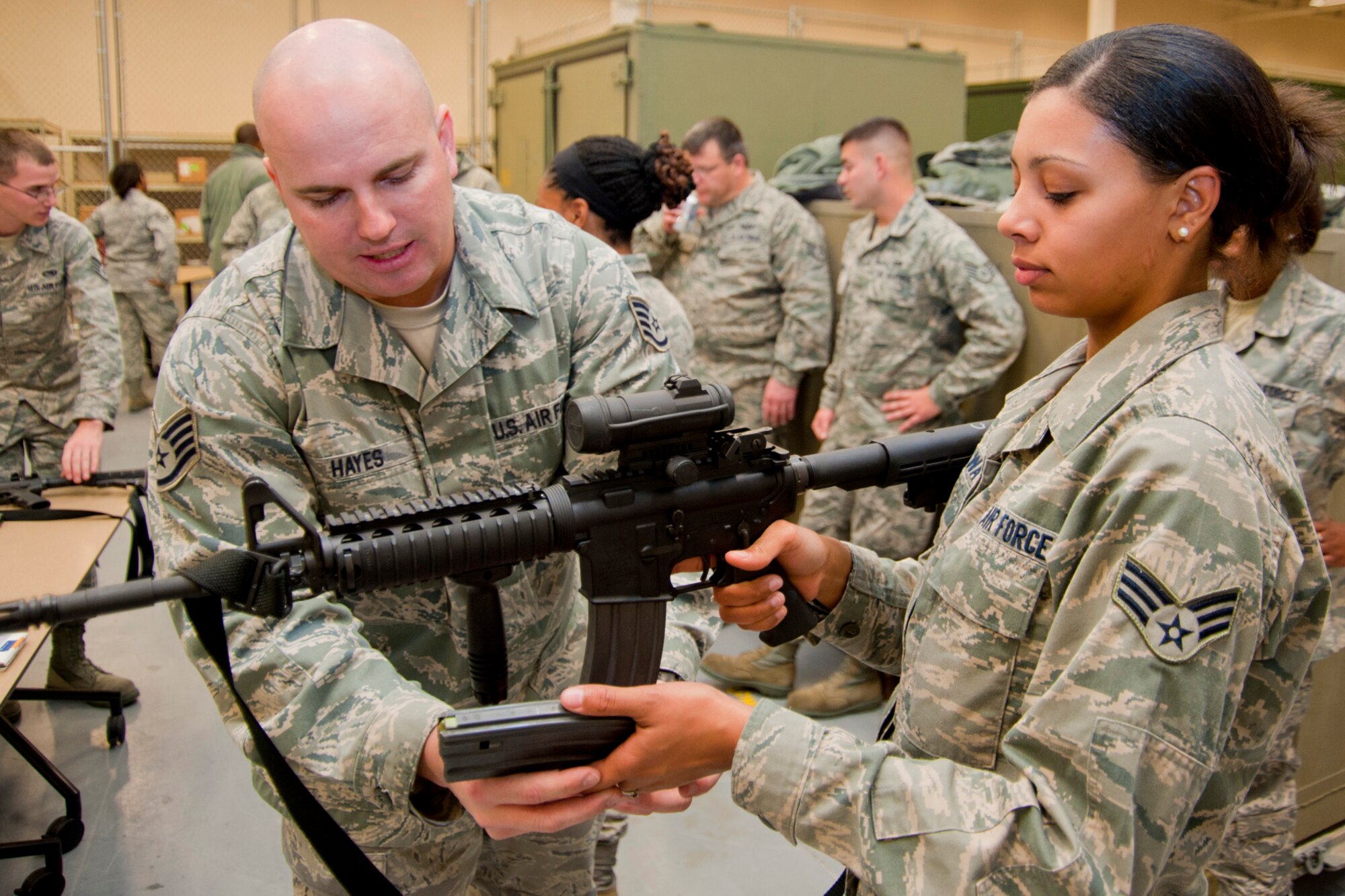 Staff Sgt. Justin Hayes, 403rd Security Forces Squadron combat arms training and maintenance member, shows Senior Airman Briana Dunnaway how to rapidly change a clip on an M-4 carbine. Airman Dunnaway, a 41st Aerial Port Squadron air transportation specialist, participated in the weapons refresher course as part of her preparation for the 403rd Wing's upcoming Operational Readiness Inspection. This is one example of the type of training Citizen Airmen perform in preparation for deploying in support of global contingencies.