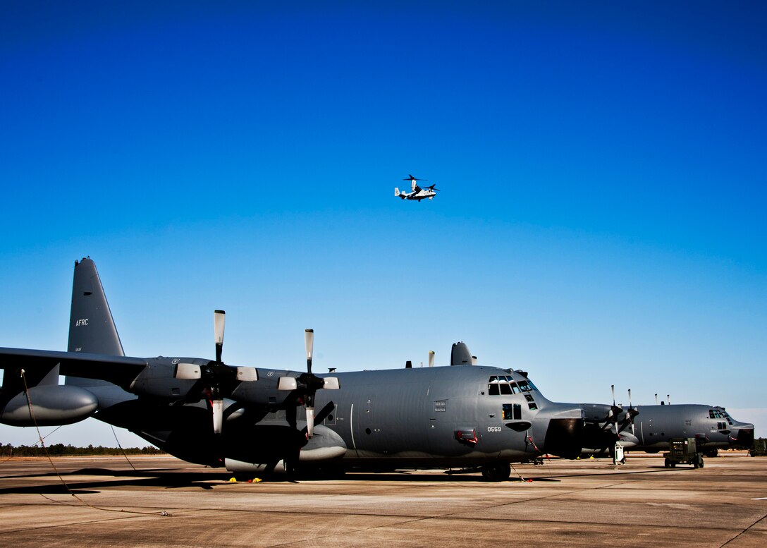 A CV-22 Osprey from the 413th Flight Test Squadron flies overhead as the 919th Special Operations Wing MC-130E Talons wait to be launched.  Duke Field’s flightline is busy again after an eight-month construction project.  (U.S. Air Force photo/Tech. Sgt. Samuel King Jr.)