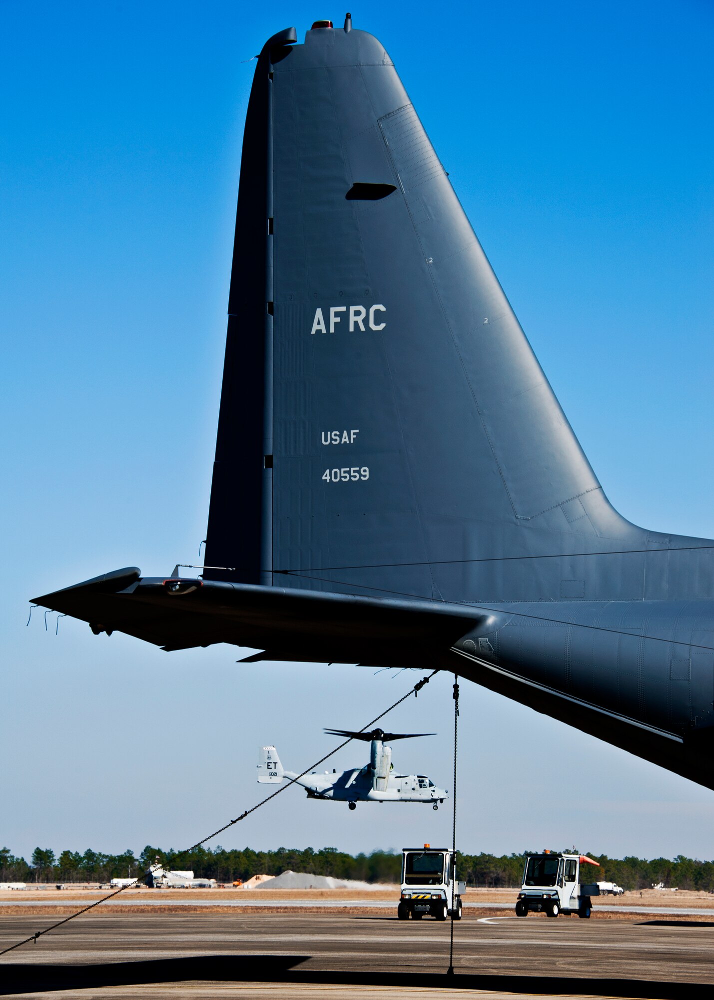 A CV-22 Osprey from the 413th Flight Test Squadron touches down as a 919th Special Operations Wing MC-130E Talon waits to be launched.  Duke Field’s flightline is busy again after an eight-month construction project.  (U.S. Air Force photo/Tech. Sgt. Samuel King Jr.)