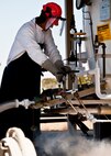 Tech. Sgt. Joshua Noel, 96th Logistics Readiness Squadron, shuts down the release valve on the liquid oxygen container after refilling the mobile aircraft oxygen refueling tank at Duke Field Feb. 11.  The tanks will be picked up and taken to the flight line to refuel the oxygen tanks on the 919th Special Operations Wing MC-130E Talons.  (U.S. Air Force photo/Tech. Sgt. Samuel King Jr.)
