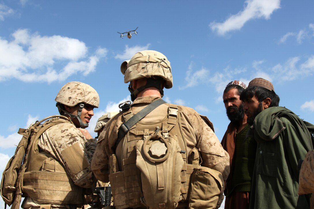 U.S. Marines and interpreters with Company I, Battalion Landing Team 3/8, 26th Marine Expeditionary Unit, Regimental Combat Team 8, speak to Afghans to offer assistance following three days of heavy rain at Turah Shah Ghundey, Helmand province, Afghanistan, Feb. 13, 2011. Elements of 26th Marine Expeditionary Unit deployed to Afghanistan to provide regional security in Helmand province in support of the International Security Assistance Force.