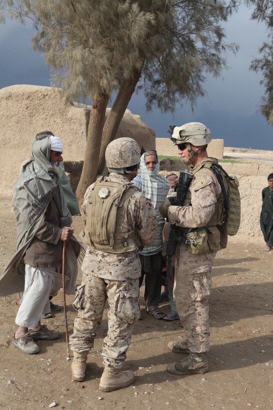 U.S. Marine Corps 1st Lt. Robert E. Malcom, platoon commander, 3rd Platoon, Company L, Battalion Landing Team 3/8, 26th Marine Expeditionary Unit, Regimental Combat Team 8, listens to an interpreter during a patrol to provide assistance to local nationals in Amanollah Kariz, Helmand province, Afghanistan, Feb. 13, 2011. Elements of the 26th Marine Expeditionary Unit deployed to Afghanistan to provide regional security in Helmand province in support of the International Security Assistance Force.